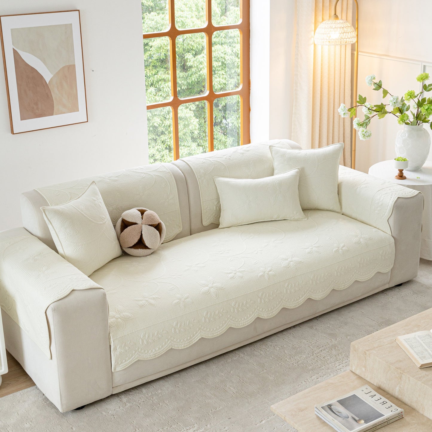 Floral Cotton Quilted Sofa Cover, Non-Slip Couch Protector with Scalloped Edges on a stylish modern living room sofa.