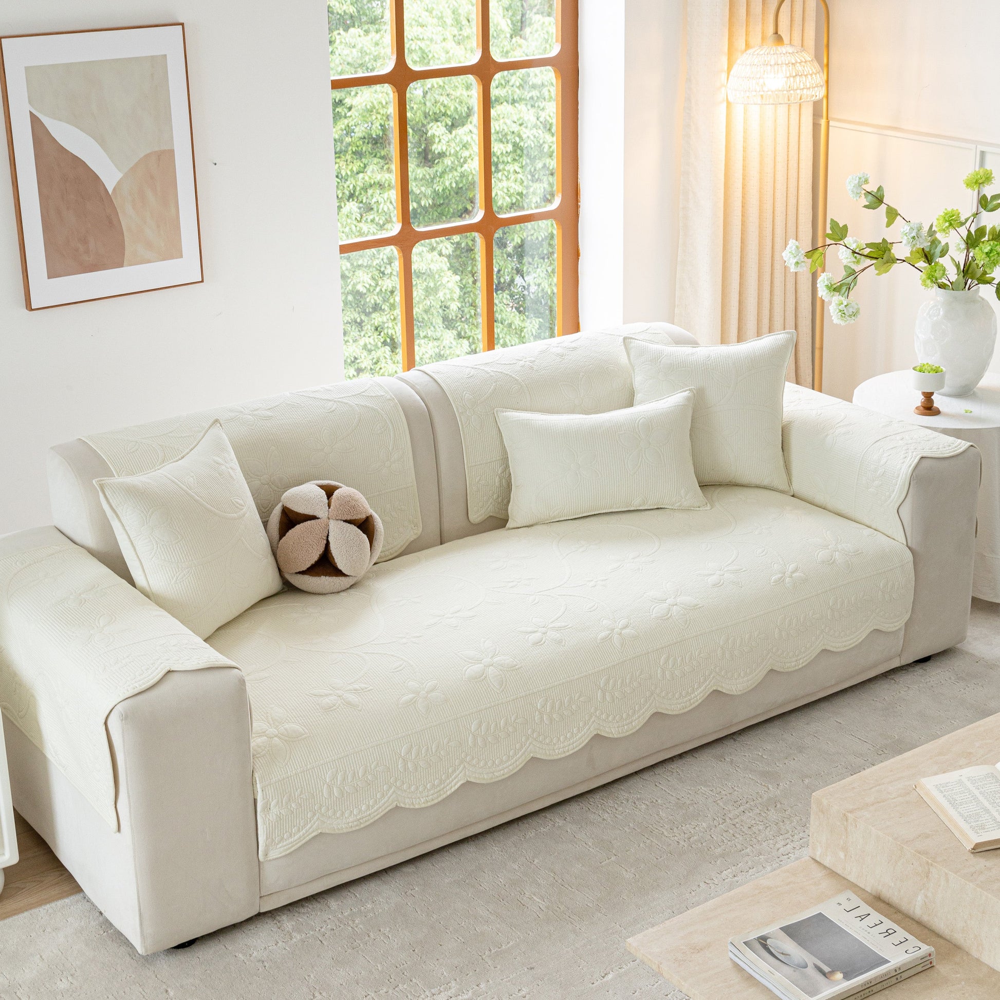 Floral Cotton Quilted Sofa Cover, Non-Slip Couch Protector with Scalloped Edges on a stylish modern living room sofa.