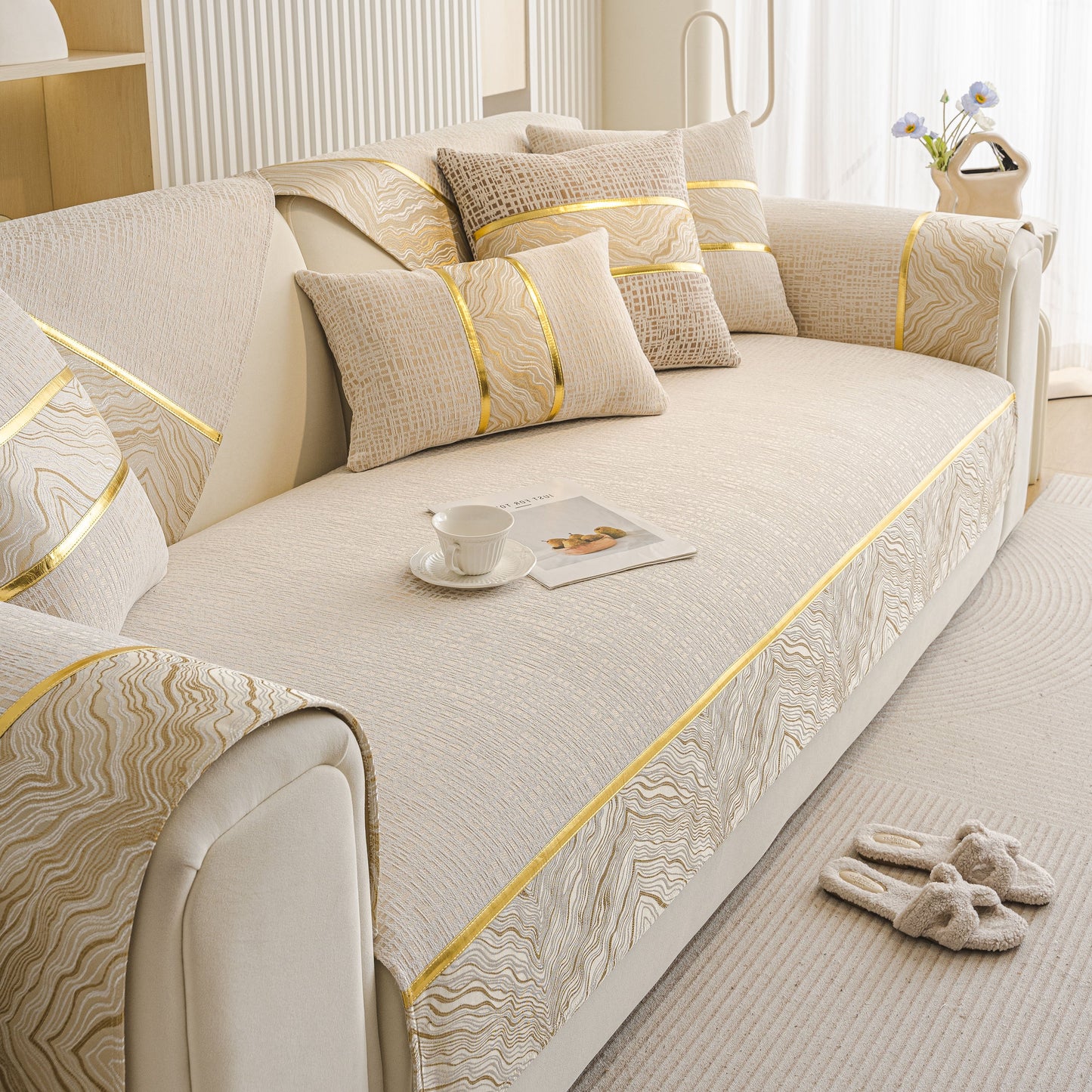 Modern Non-Slip Couch Slipcover, Soft, Durable & Washable Furniture Protector with gold marble-style trim on a beige sofa.