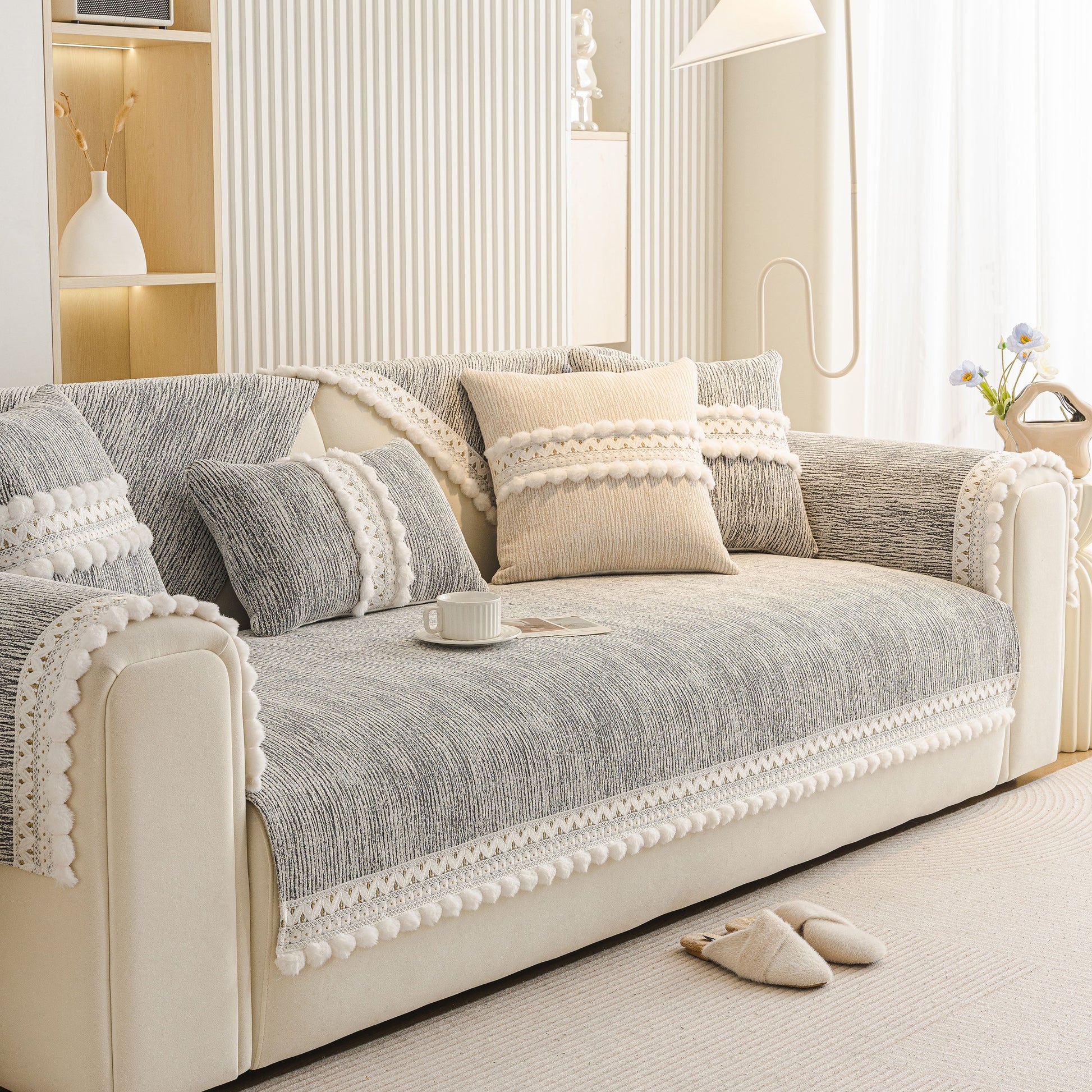 Soft Chenille Sectional Sofa Cover with Pom Pom Trim – Non-Slip Couch Protector on beige sofa in light interior setting