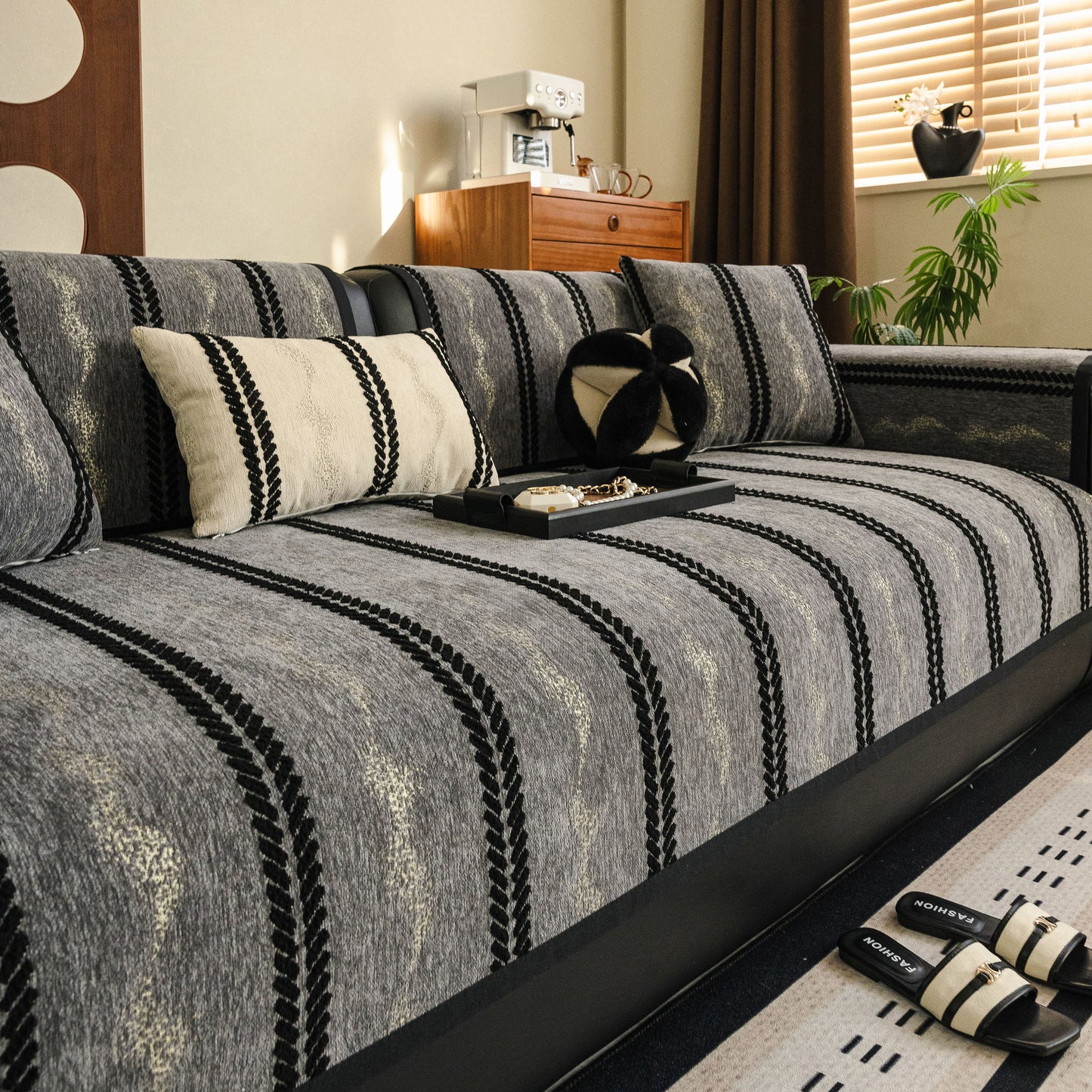 Non-Slip Sofa Cover with Thick Chenille Texture Woven Stripe Couch Protector Throw on a modern living room sofa with decor.