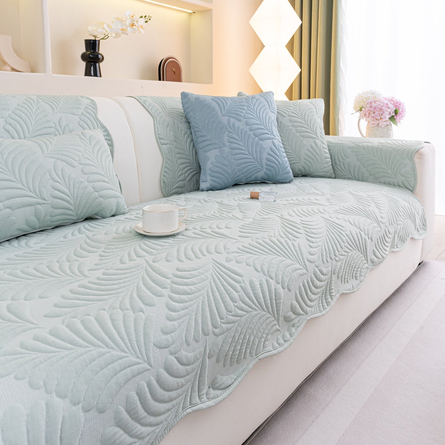 Sofa Cover for Leather & Fabric Couches, 3D Leaf Embossed Quilted Furniture Covers on a beige sofa with cushions