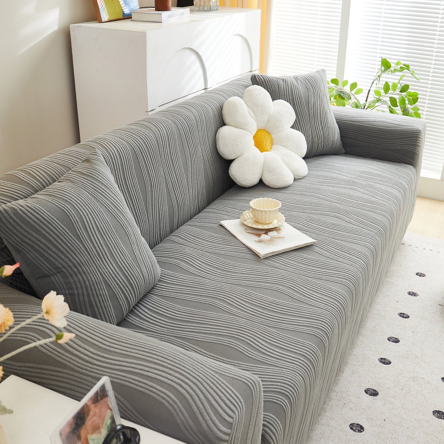 Textured Wave Stretch Sofa Couch Cover, Soft Washable Spandex Furniture Slipcovers on gray couch with a daisy pillow.