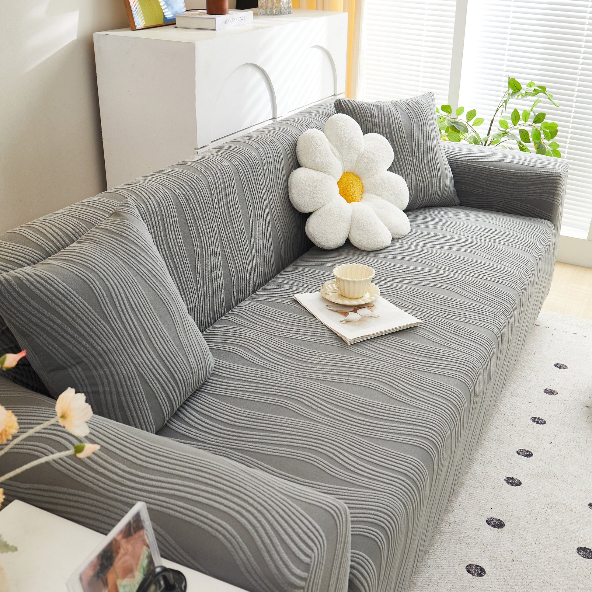 Textured Wave Stretch Sofa Couch Cover, Soft Washable Spandex Furniture Slipcovers on gray couch with a daisy pillow.