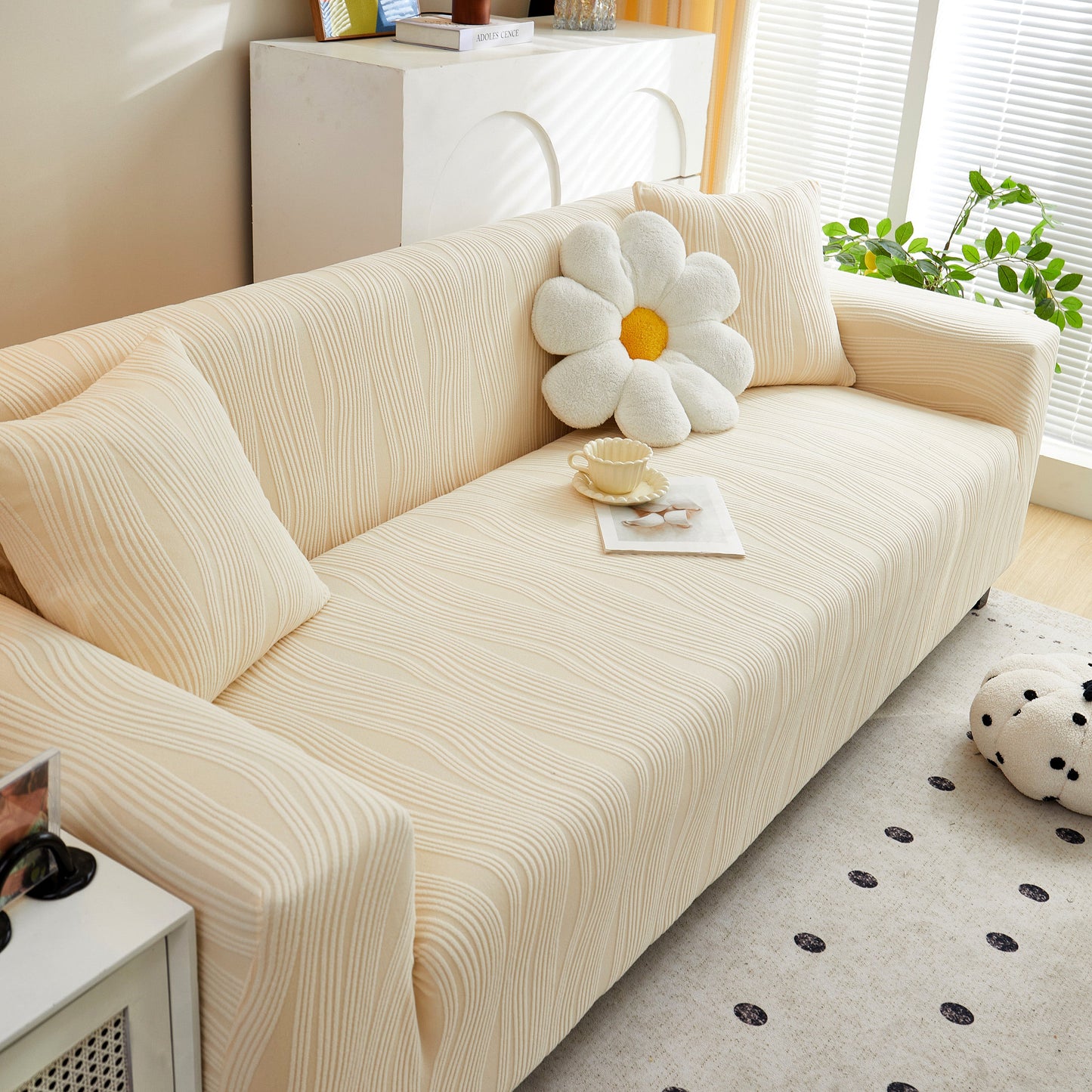 Textured Wave Stretch Sofa Couch Cover on beige sofa, showcasing soft washable spandex slipcovers, with cushion and tea setup.