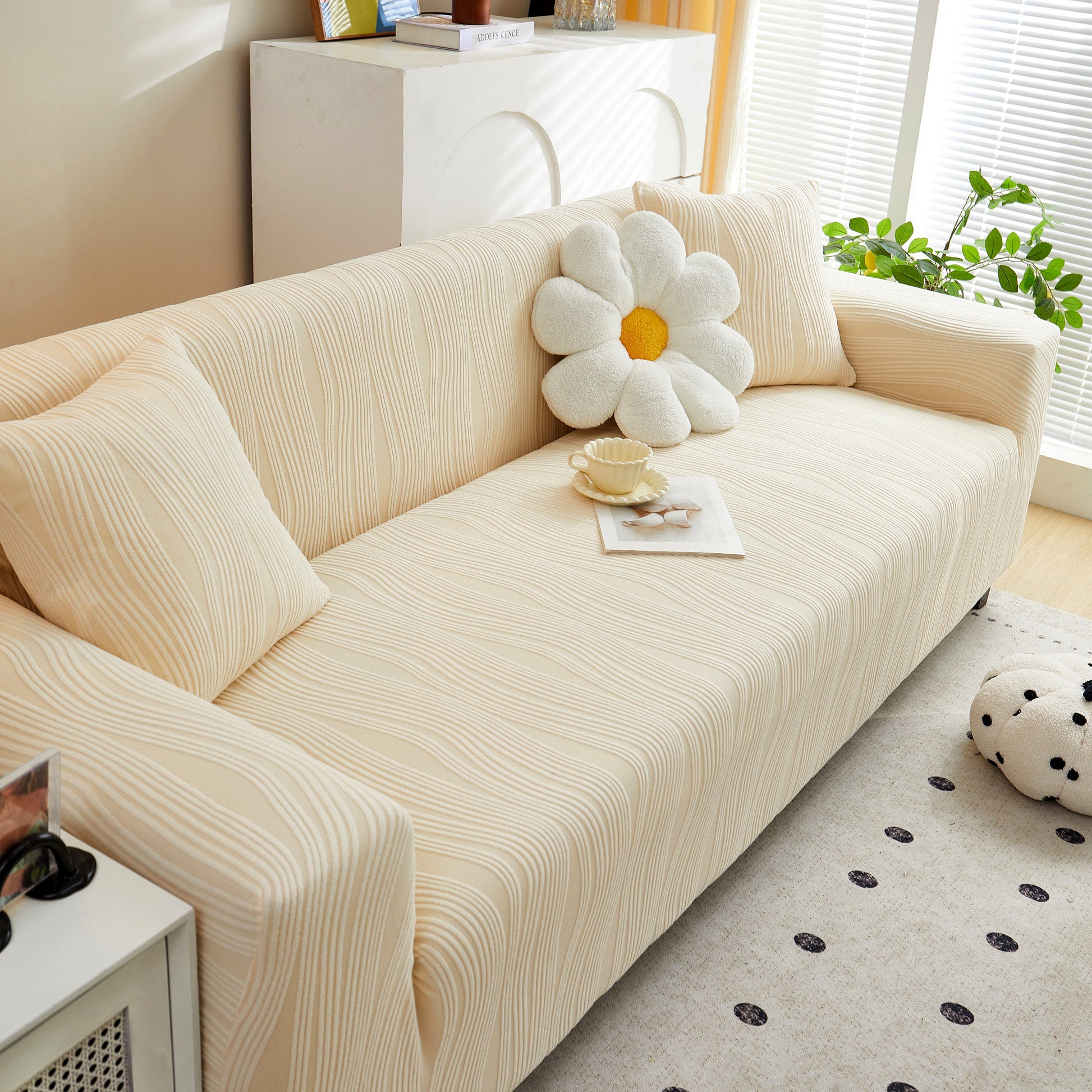 Textured Wave Stretch Sofa Couch Cover on beige sofa, showcasing soft washable spandex slipcovers, with cushion and tea setup.