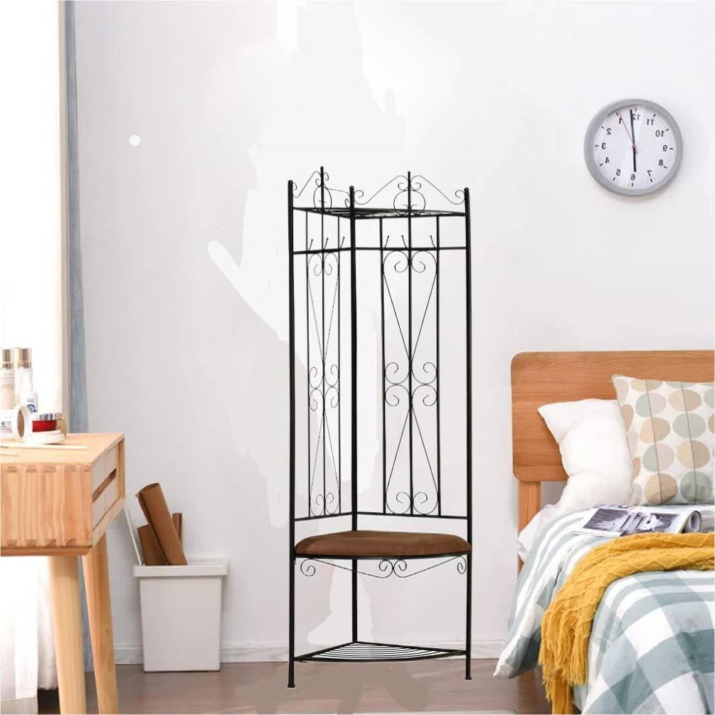 Black Metal Scrolling Corner Hall Tree Coat Rack Storage Bench in a bedroom setting with clock and wooden furniture.