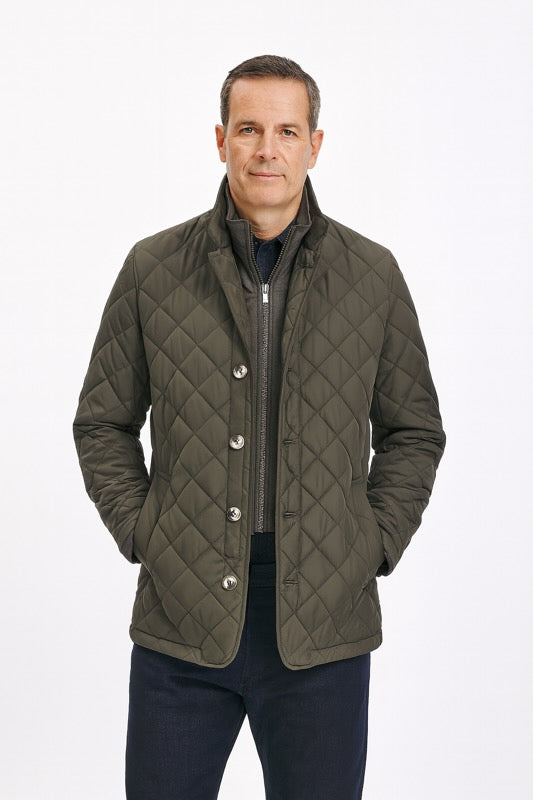 Man wearing Dual-Layer Quilted Nylon Jacket - Gray with diamond-quilt pattern, showcasing tailored fit and refined details, hands in pockets.