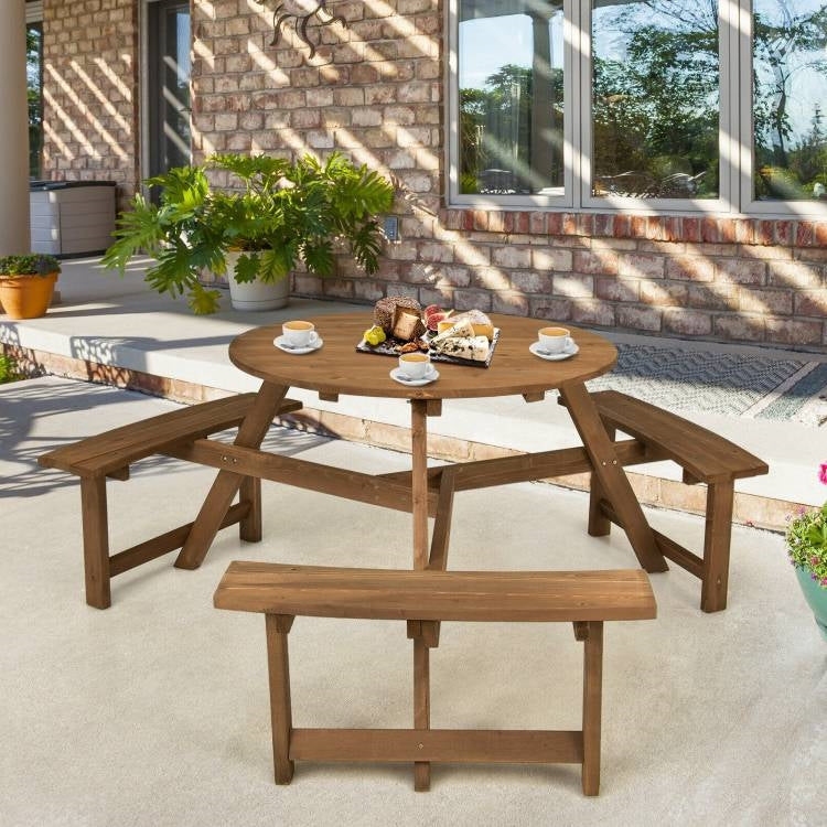 Outdoor Solid Wood Round Picnic Table Set with Umbrella Hole and 3 Benches on a patio with plants and coffee cups.