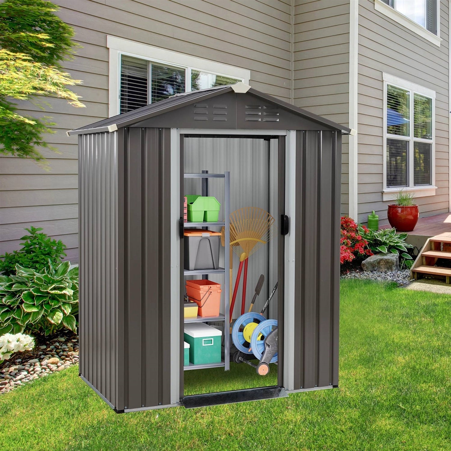 5 x 3 ft. Outdoor Grey Metal Garden Storage Shed with lockable door and sloped roof in a backyard setting.