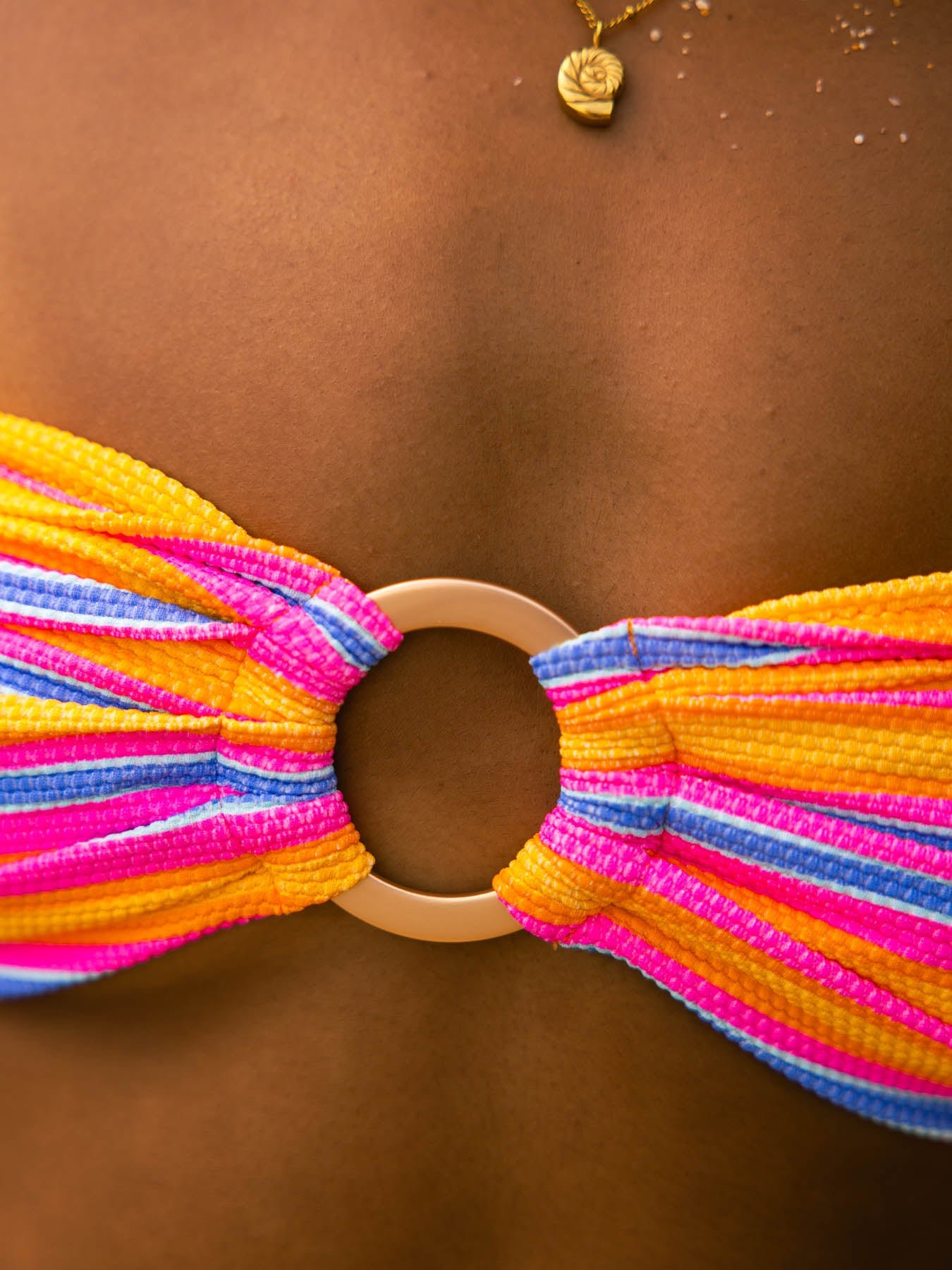 Close-up of kenna top - sahara strapless bandeau with gold ring, showcasing vibrant honeycomb fabric for minimal tan lines.