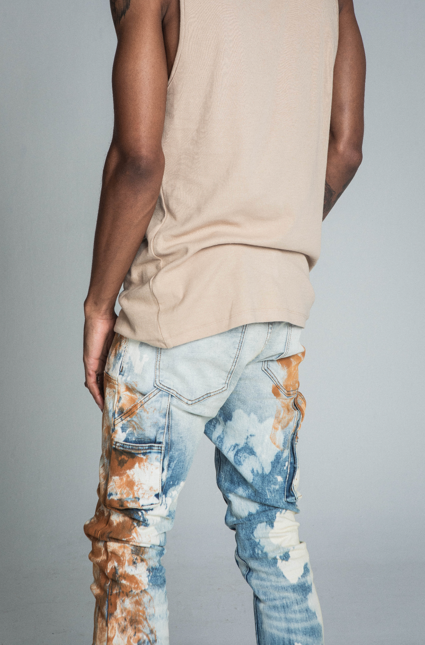 AJ19SK OIL PAINT STACKED JEANS with mid-rise waist, stretchy fabric, cargo pocket, and oil paint effect design for a trendy look.