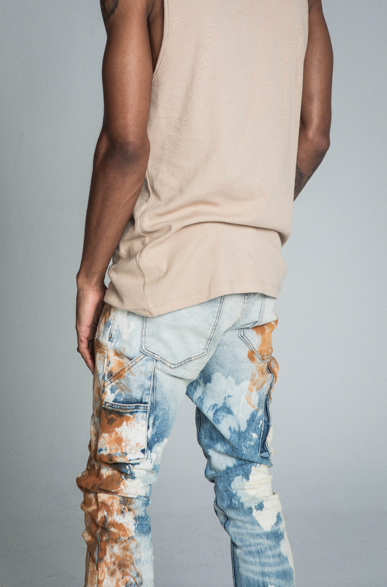 AJ19SK OIL PAINT STACKED JEANS with mid-rise waist, stretchy fabric, cargo pocket, and oil paint effect design for a trendy look.