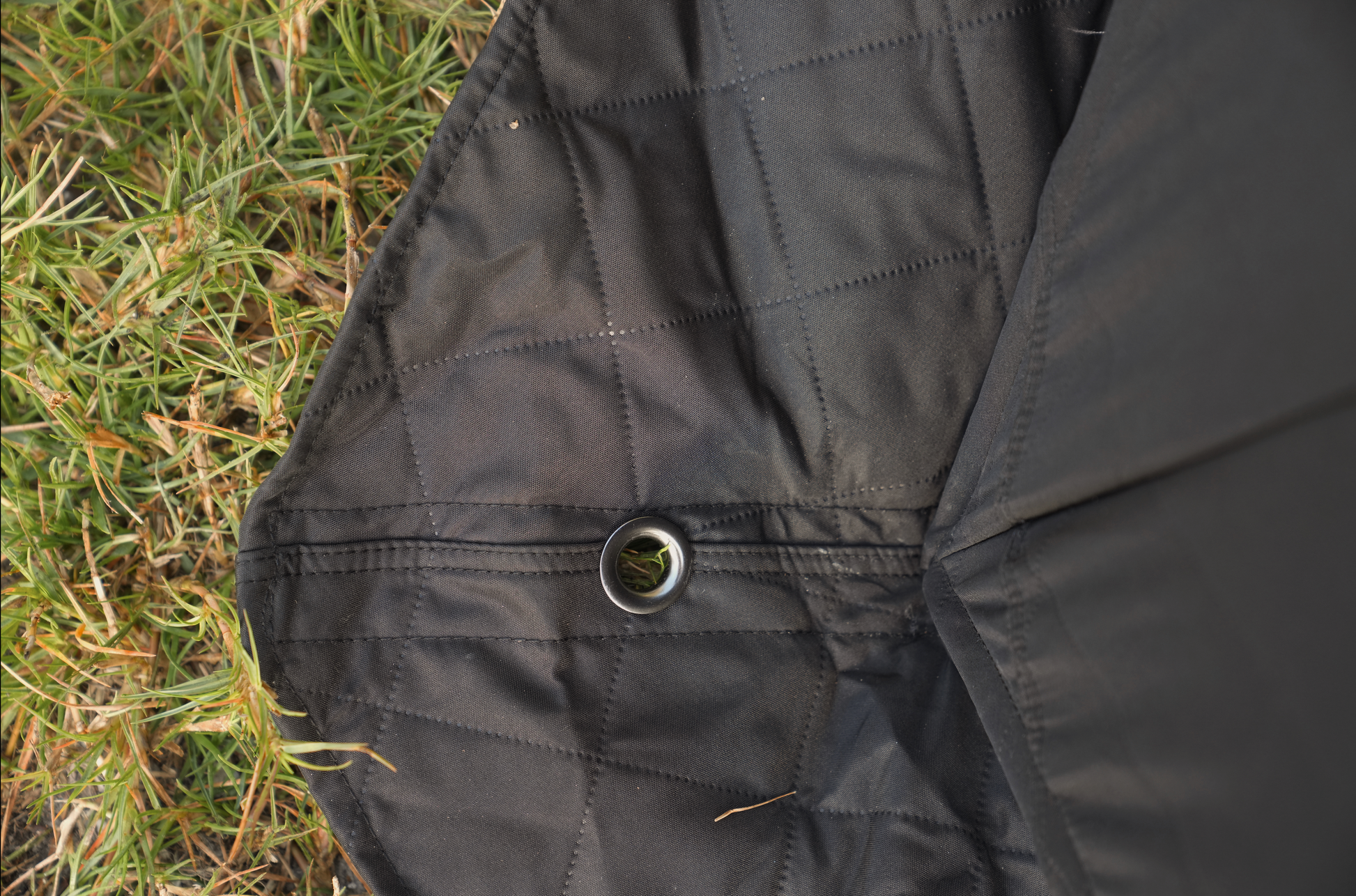 Close-up of Dome Sauna Tent (8-person; tent only) fabric detailing with grass background