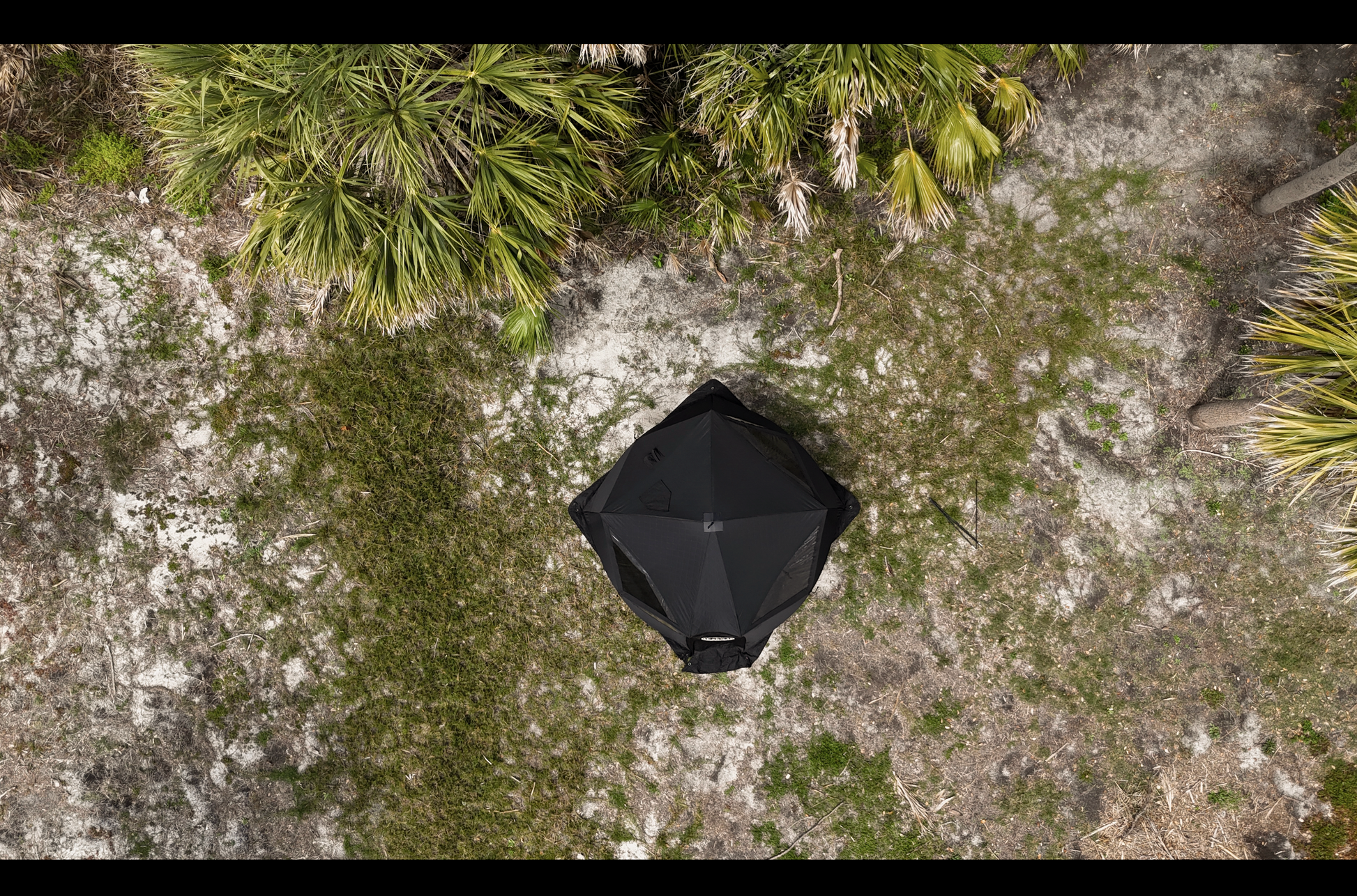 Aerial view of Nova 6 Sauna Tent (6-person; tent only) set in a natural outdoor setting with surrounding greenery.
