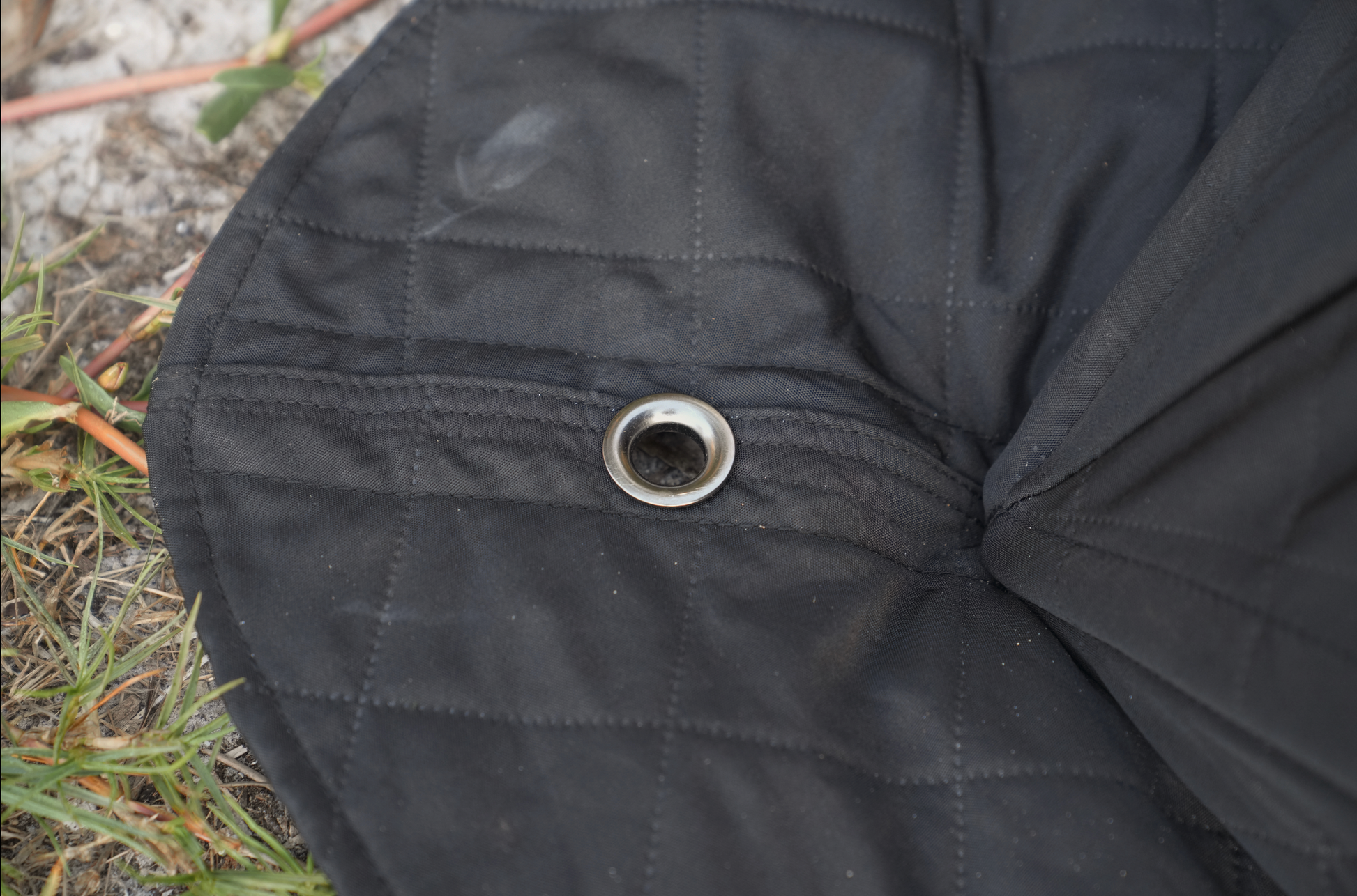 Base of Nova 6 Sauna Tent (6-person; tent only) with detailed view of fabric and stitching near metal grommet
