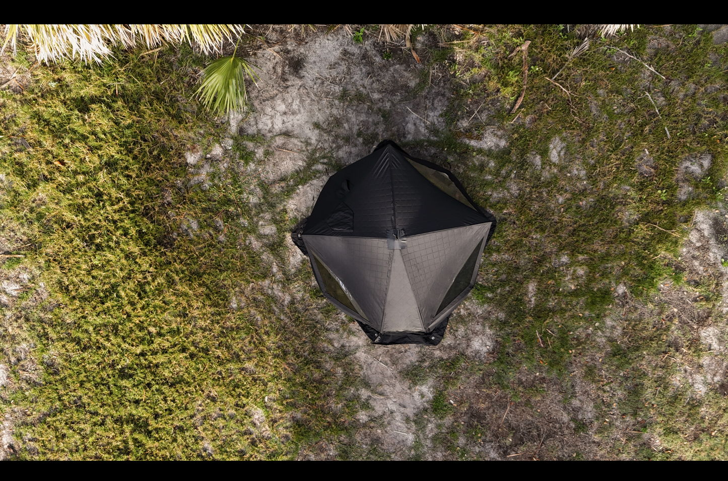 Aerial view of Nova 4 Sauna Tent (4-person; tent only) set up on grassy terrain.