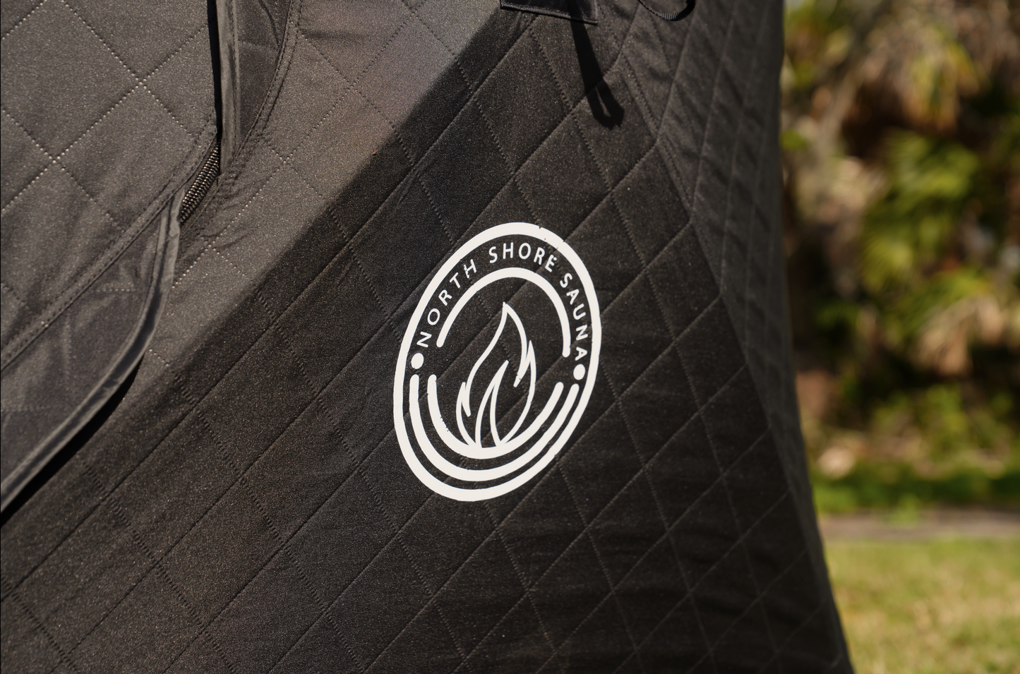 Mini Cube Sauna Tent (2-person; tent only) with North Shore Sauna logo outdoors