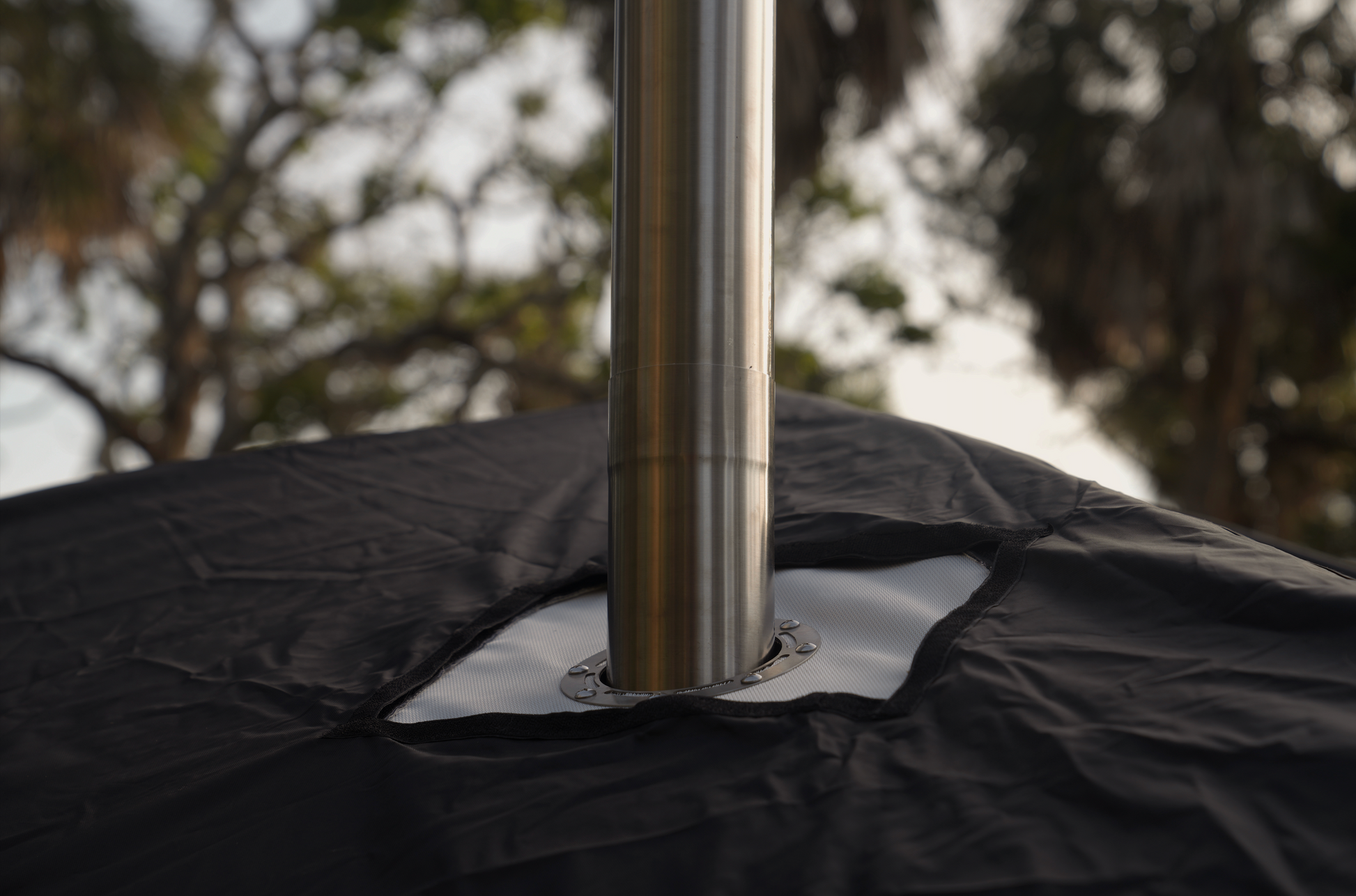 Chimney of Nova 4 Sauna Tent Starter Package (4-person) with wood burning stove in outdoor setting