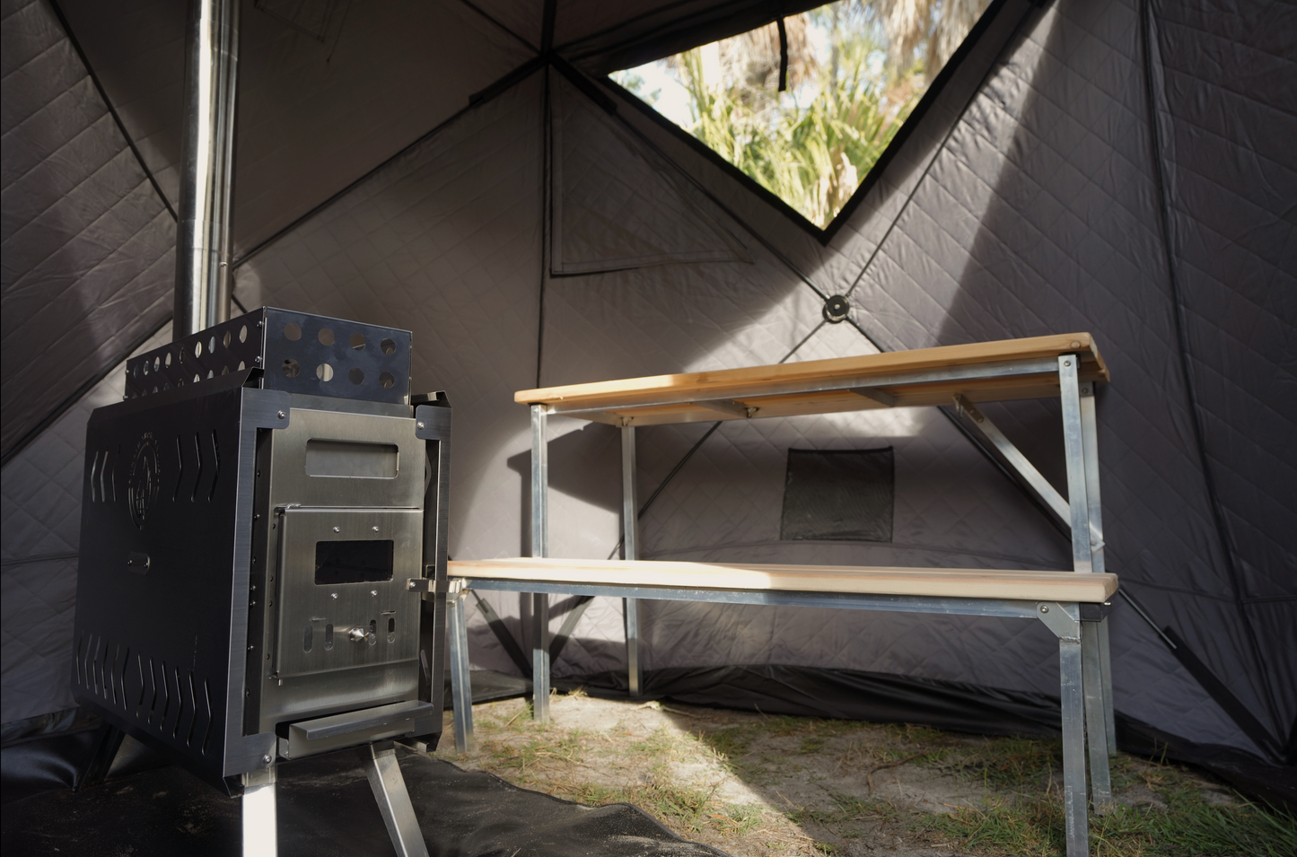 Interior of Nova 4 Sauna Tent Pro Package (4-person) showing wood stove and portable bench.