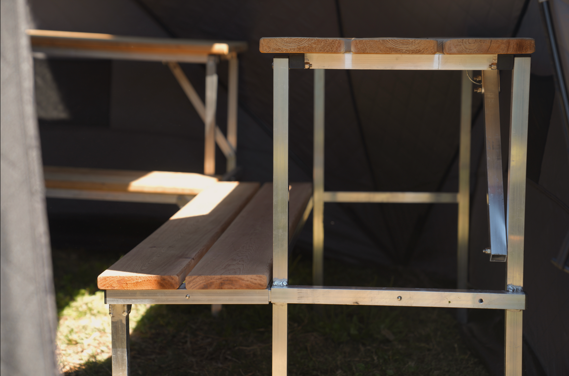 Interior view of Nova 6 Sauna Tent Pro Package (6-person) showing wooden benches and supports, emphasizing durability and design.
