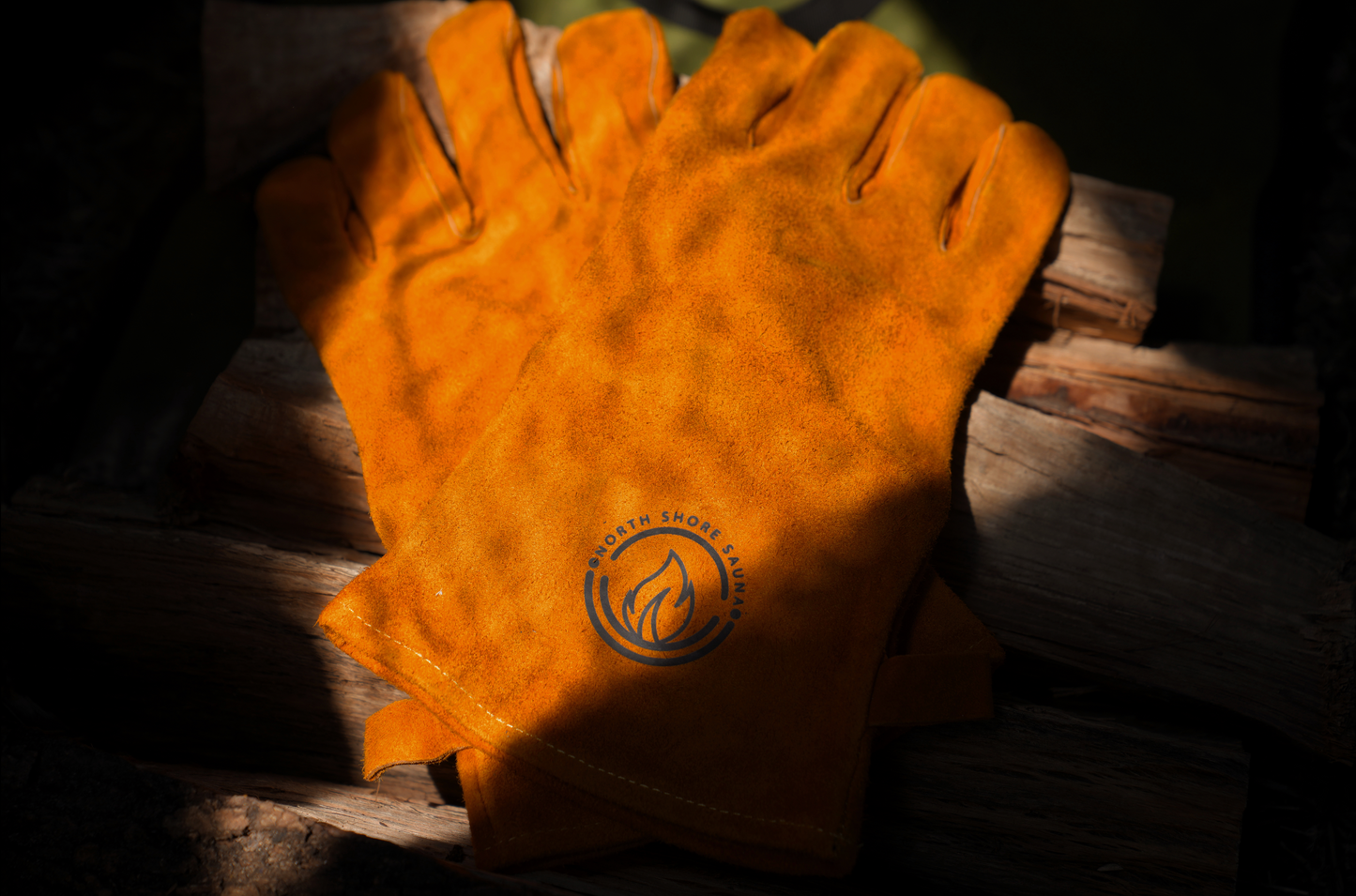 Orange gloves on wooden logs, part of the Nova 6 Sauna Tent Pro Package (6-person) for outdoor and backyard use.