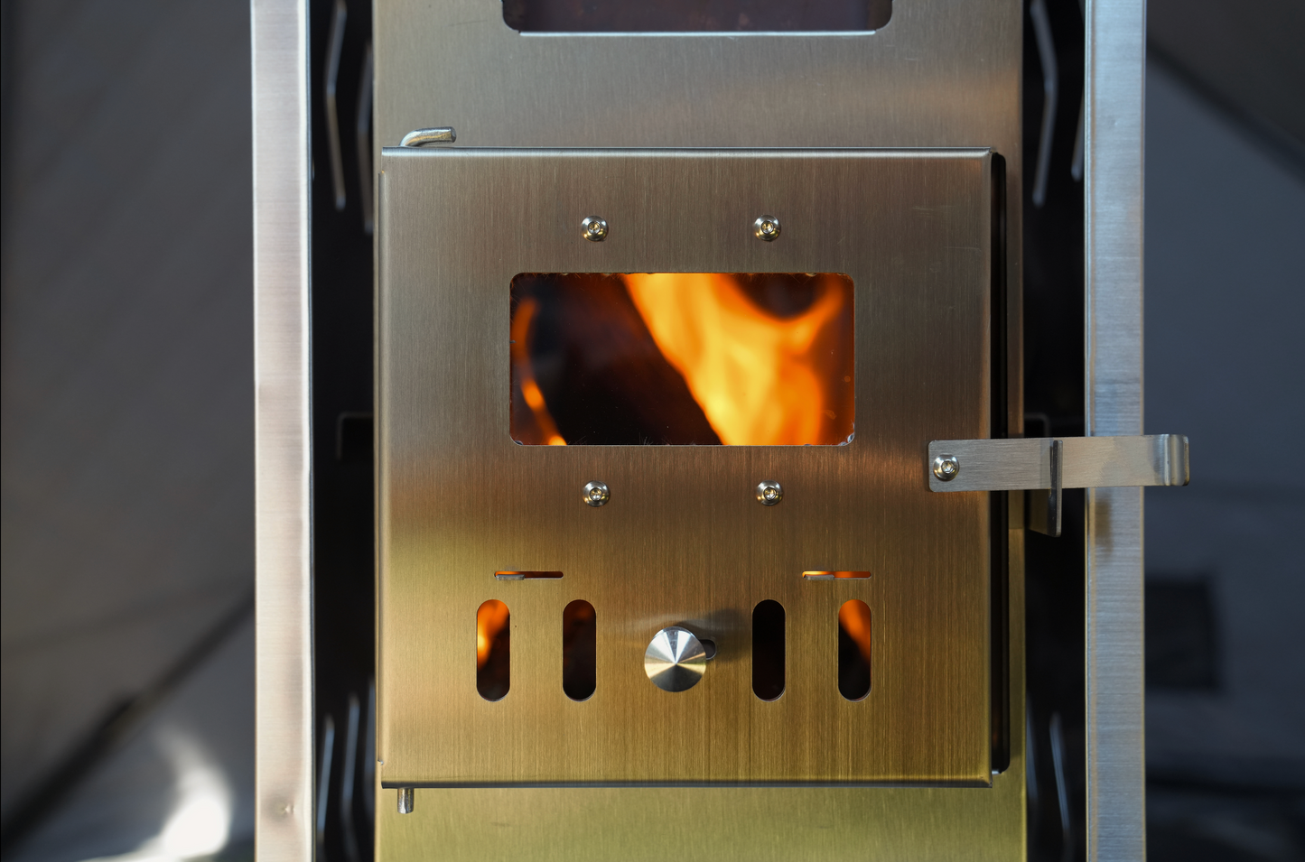 Stainless steel stove inside Dome Sauna Tent Pro Package (8-person) glowing with fire