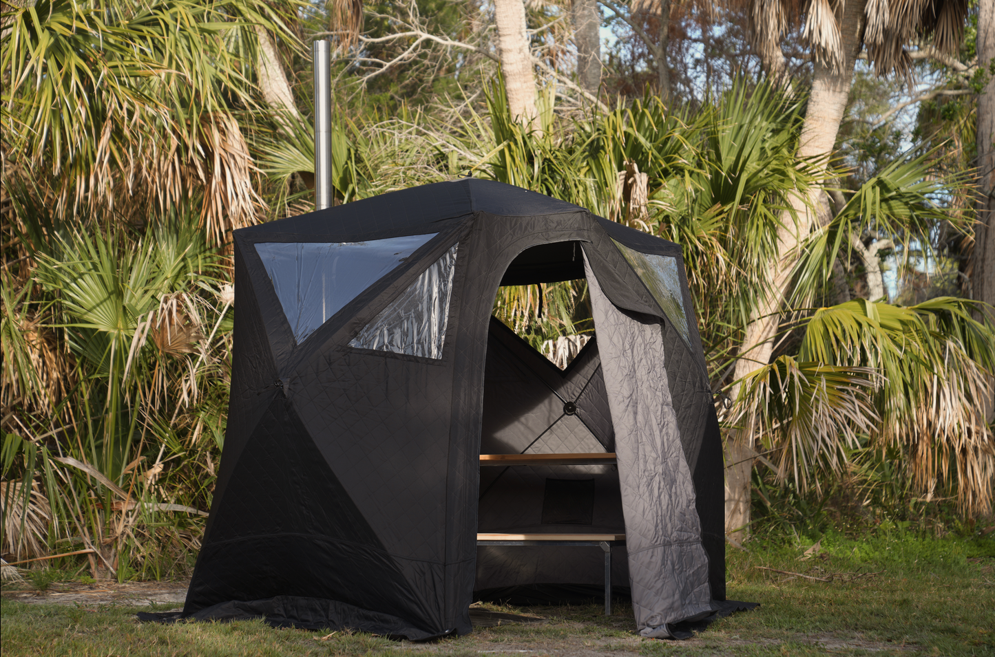 Nova 4 Sauna Tent Premium Package (4-person) set up outdoors with wood-fired stainless-steel stove and portable sauna bench.