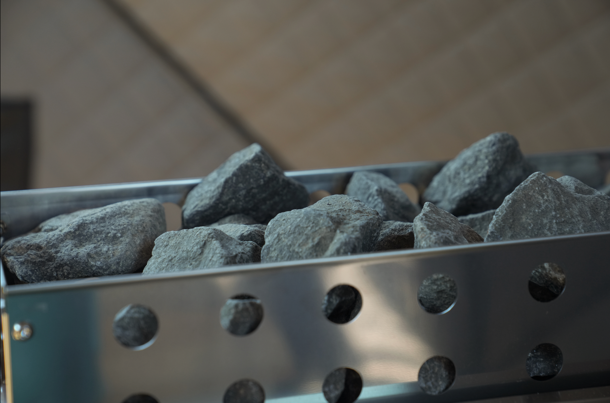 Stove rock basket with sauna rocks from Nova 6 Sauna Tent Premium Package (6-person), enhances heat distribution and sauna experience.