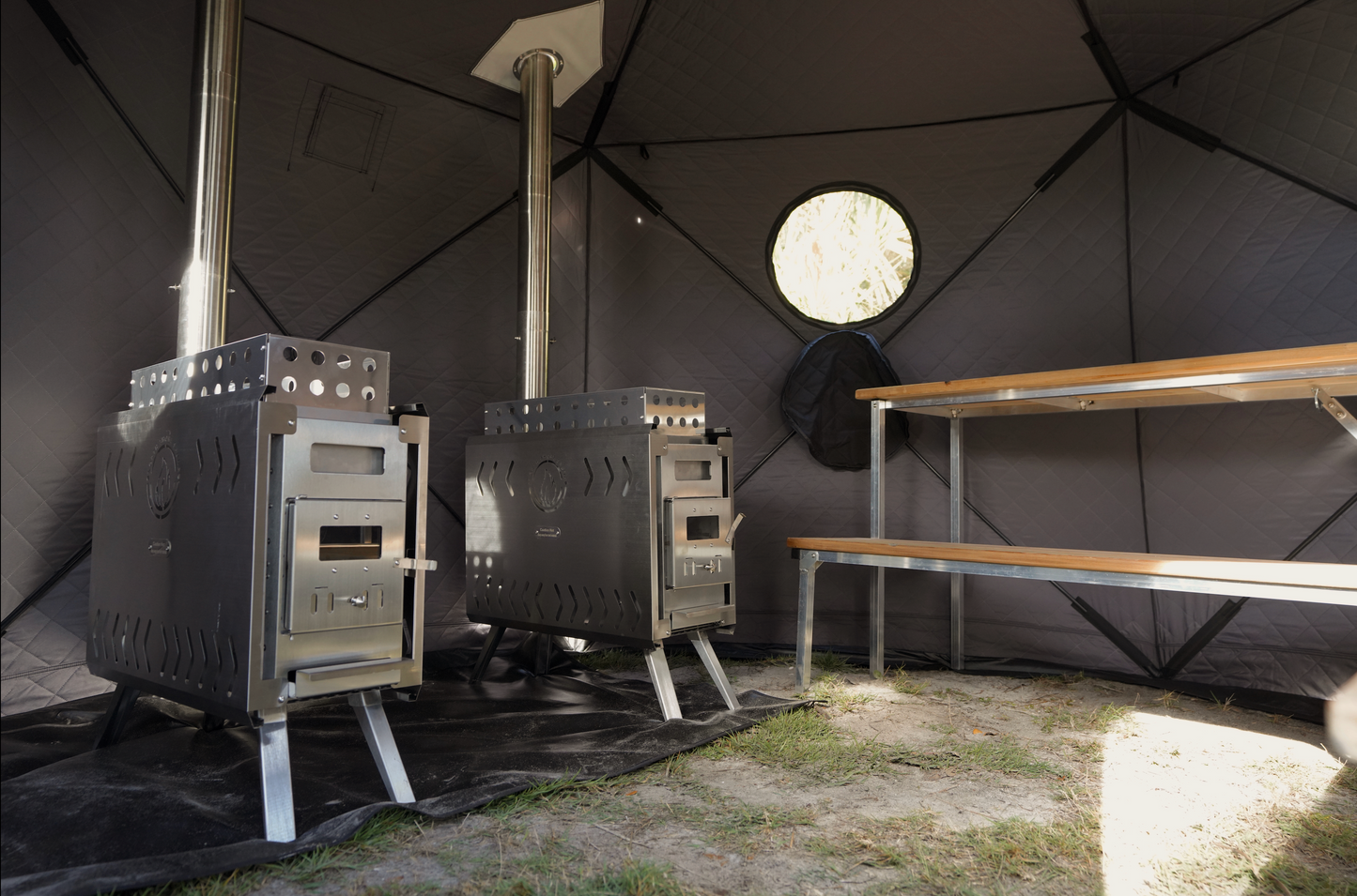 Interior view of Dome Sauna Tent Premium Package (8-person) showcasing dual stoves and benches for a luxurious spa experience.