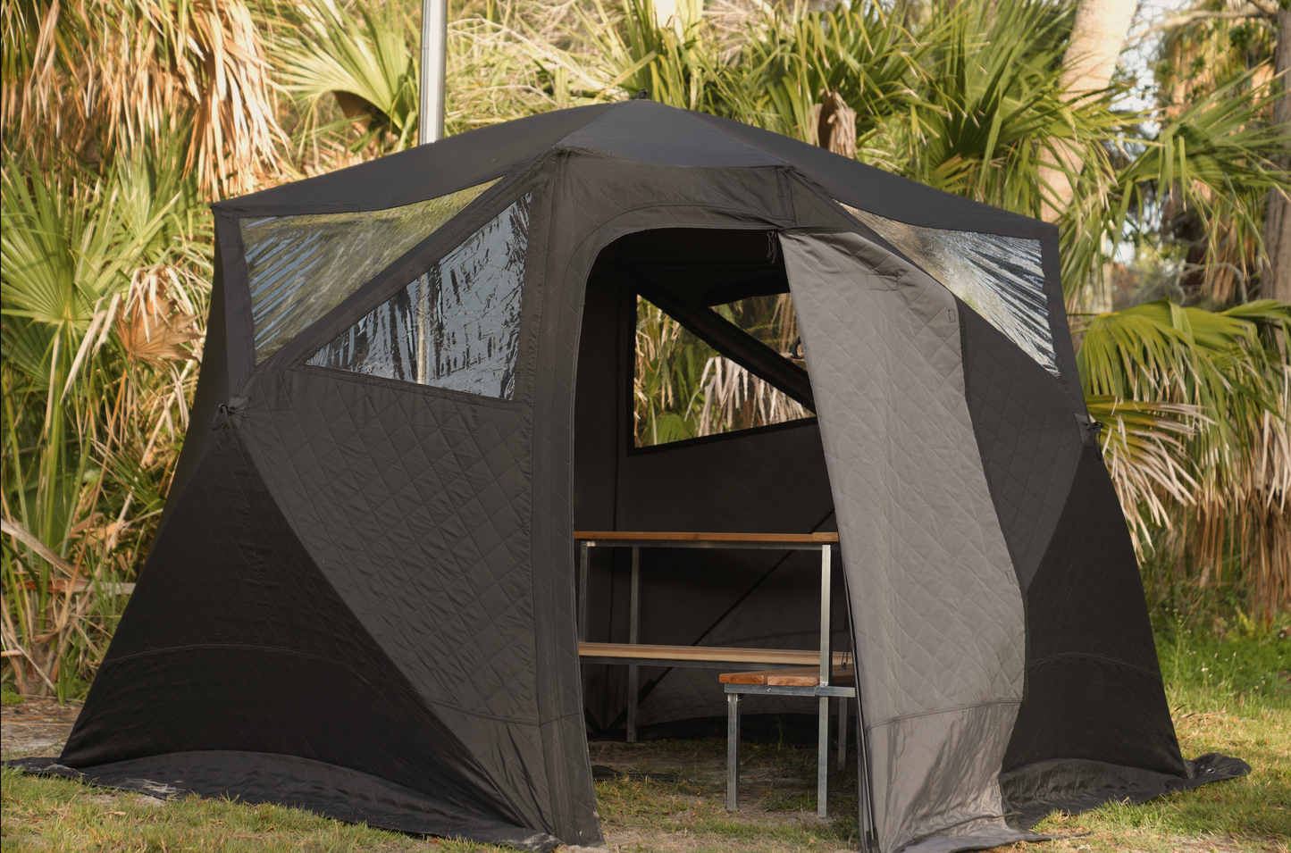 Nova 6 Sauna Tent Elite Experience Package (6-person) set up outdoors with seating inside.