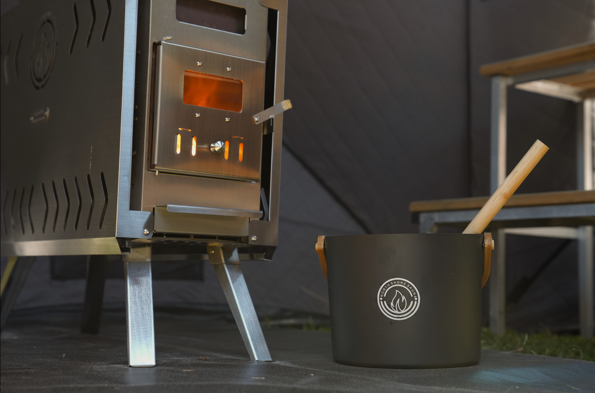 5L Black Aluminum Sauna Bucket and Ladle Set with Elegant Bamboo Handles beside a sauna heater