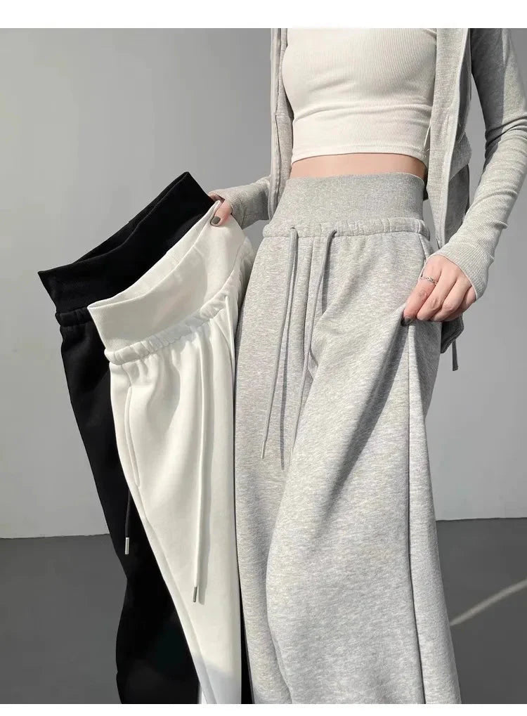 Woman holding Gray High-Waist Loose Wide-Leg Straight Pants Women with white and black options.