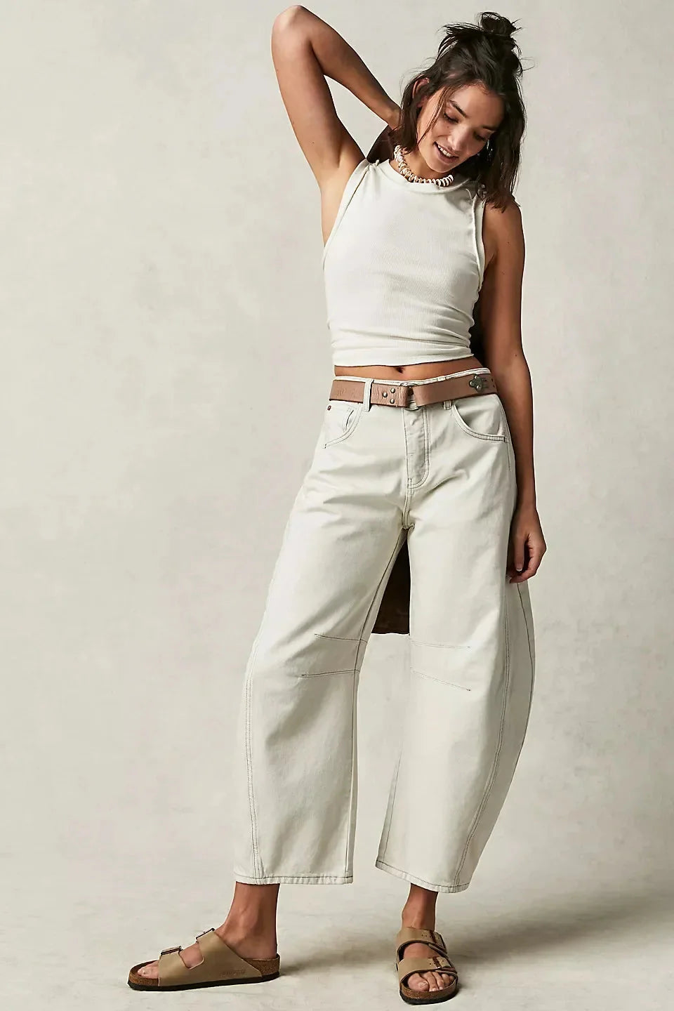Woman in white tank top wearing Women’s Elastic Waist High Waisted Jeans with a loose fit and cropped cut for casual outings.