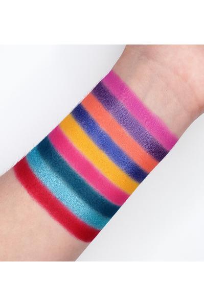 Color swatches of SHOCKED - GES13 eyeshadow palette on arm showcasing vibrant matte and shimmer shades.
