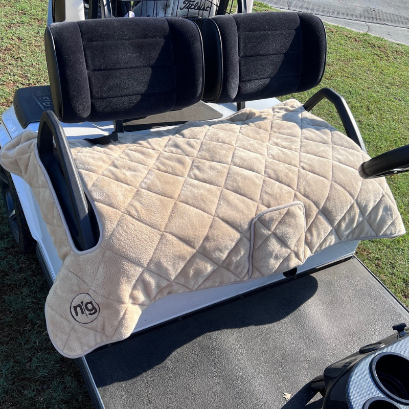 Plush tan Golf Cart Seat Covers by Nailed Golf on a cart, offering style and comfort with universal fit and soft lining.