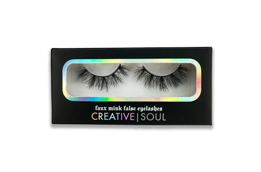 Spell fluffy faux mink false eyelashes in packaging, vegan and cruelty-free, featuring a thin flexible band, includes free brush.