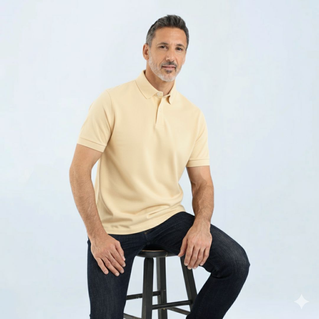 Man wearing Short Sleeve Perfect Polo with StaySharp™ Collar on a stool, showcasing modern fit and tailored comfort for all-day ease.