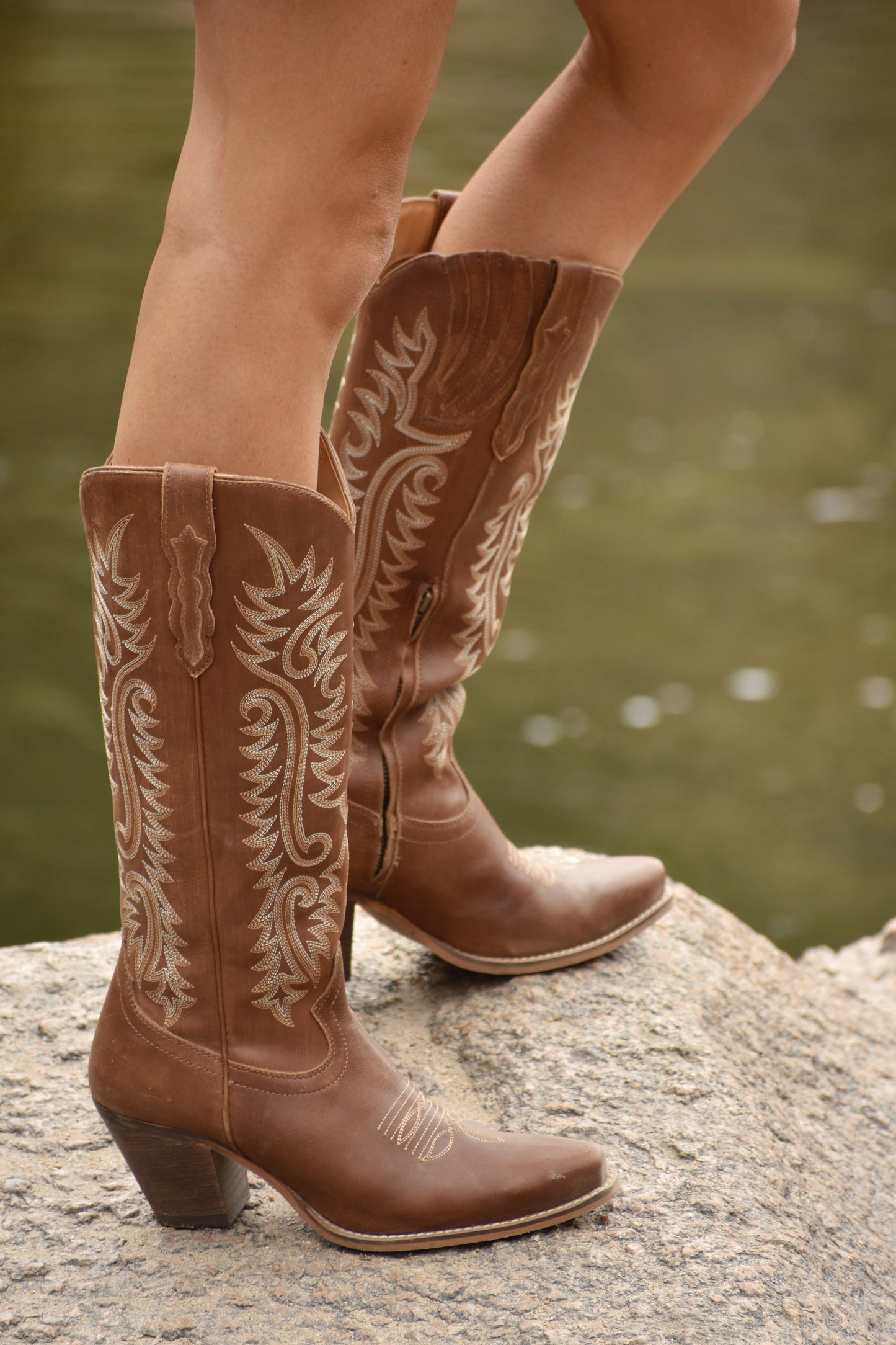 Sylvia Prairie Leather Boots with white embroidery on riverbank