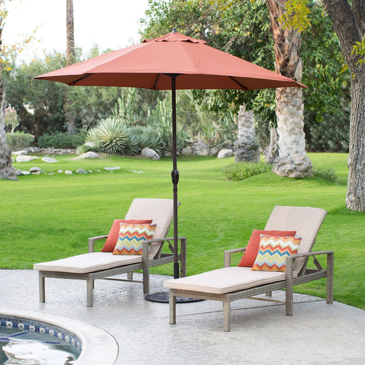 9-Ft Patio Umbrella in Terracotta with Metal Pole and Tilt Mechanism beside lounge chairs by a pool