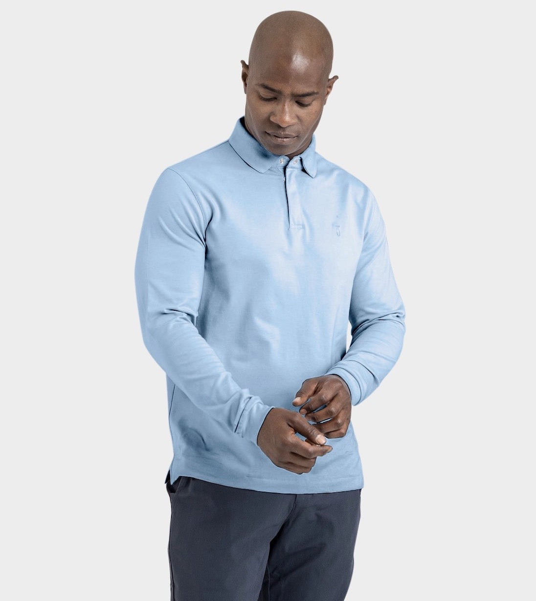 Man wearing Baobab Long Sleeve Perfect Polo in light blue with StaySharp™ collar and tailored fit.