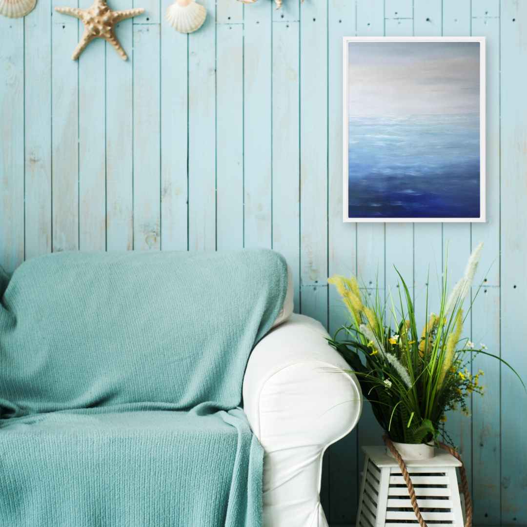 Finding Peace with the Ocean canvas print on a beach-themed wall above a cozy sofa.