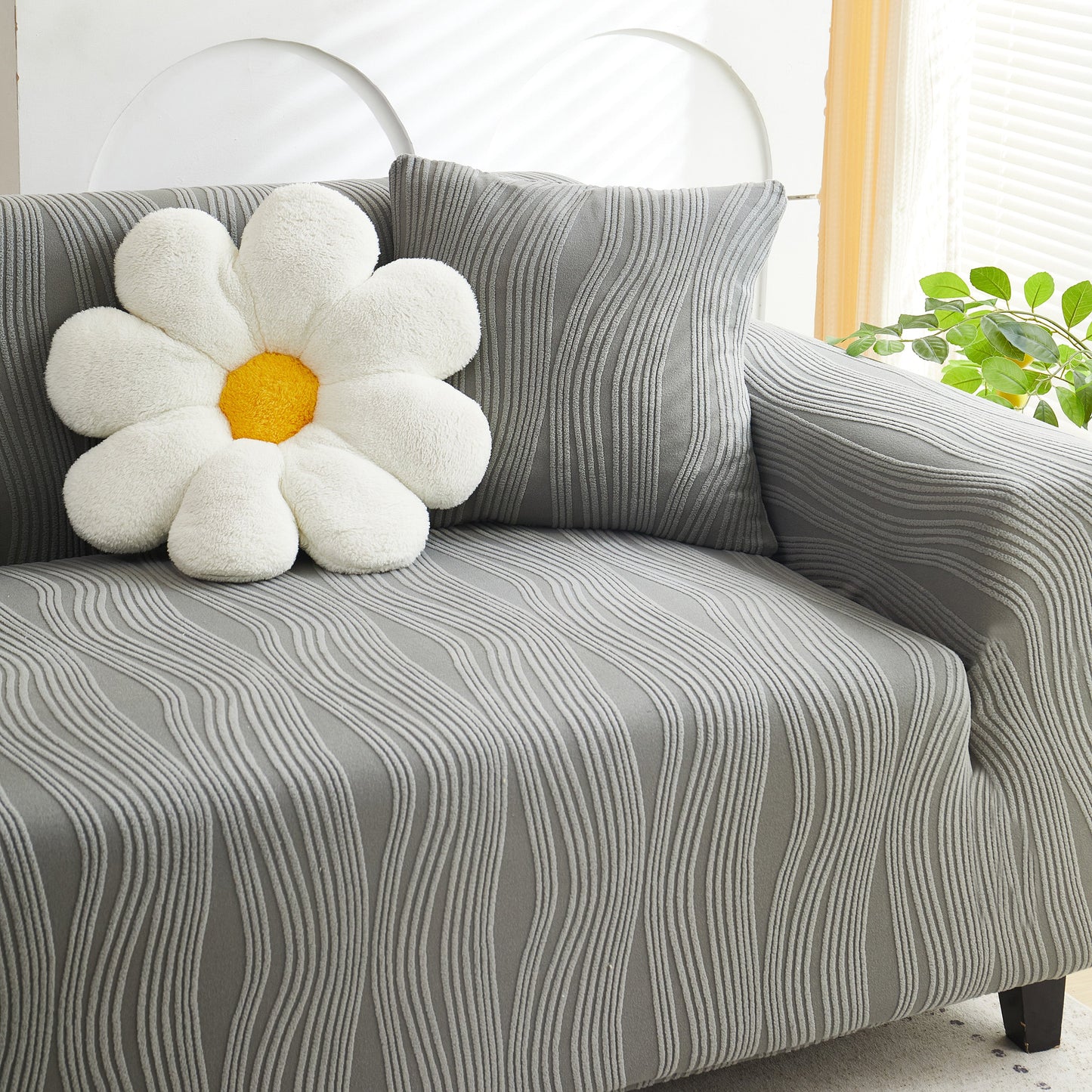 Textured Wave Stretch Sofa Couch Cover, Soft Washable Spandex Furniture Slipcovers on a gray sofa with a daisy pillow.