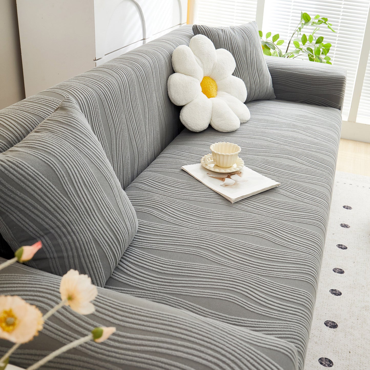 Textured Wave Stretch Sofa Couch Cover in gray with daisy pillow, Soft Washable Spandex Furniture Slipcovers, modern living room decor.