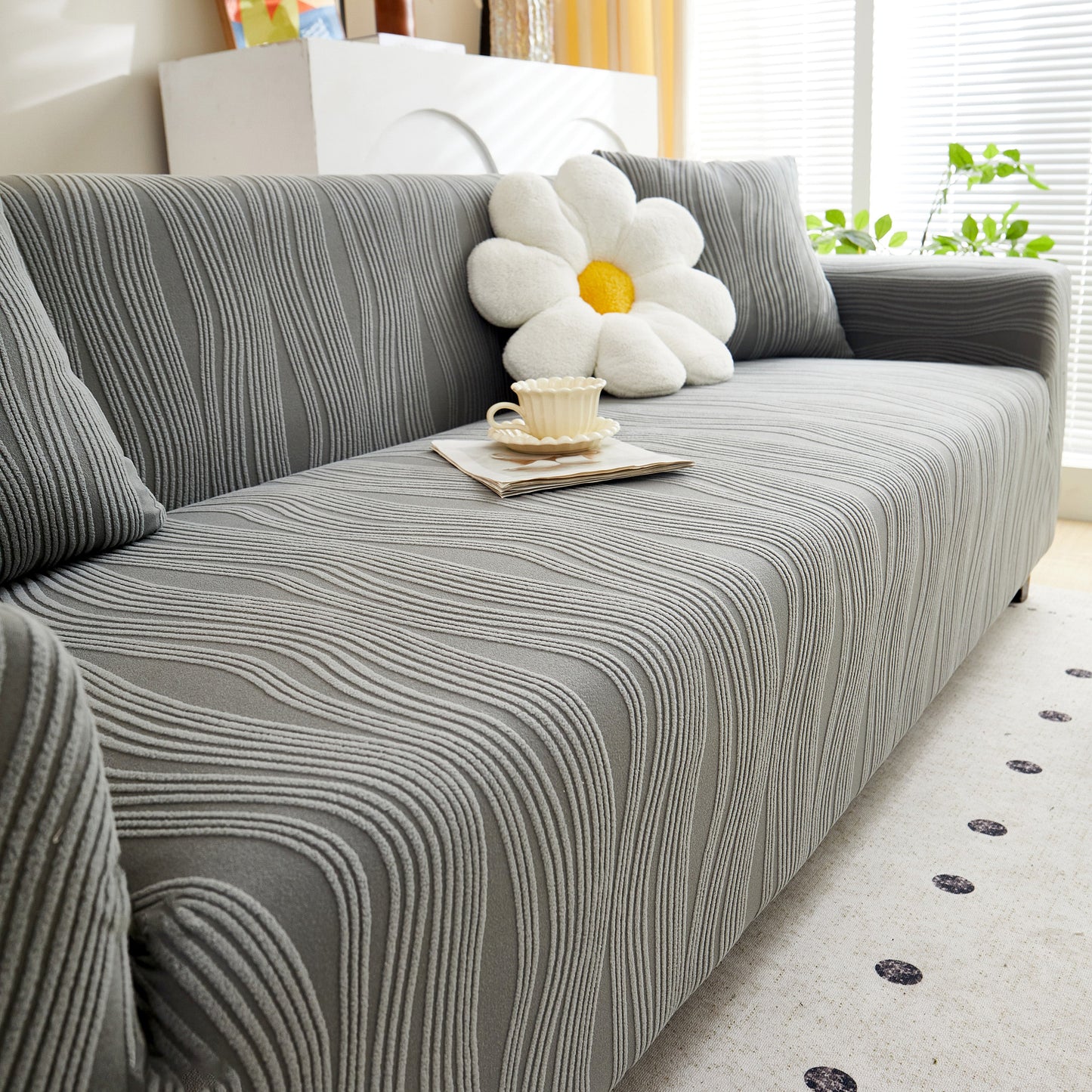 Textured Wave Stretch Sofa Couch Cover, Soft Washable Spandex Furniture Slipcovers on a modern sofa with a floral cushion.