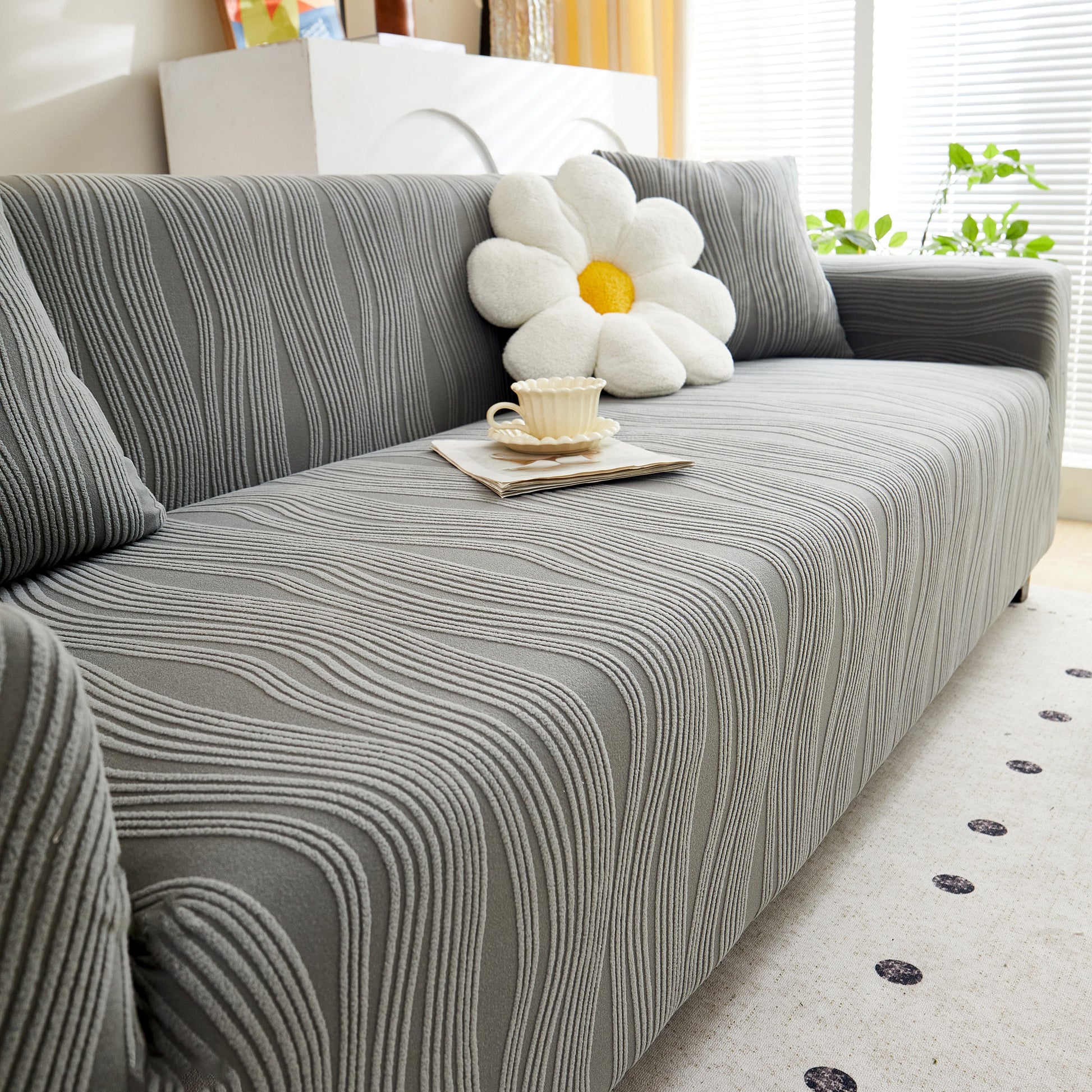 Textured Wave Stretch Sofa Couch Cover, Soft Washable Spandex Furniture Slipcovers on a modern sofa with a floral cushion.