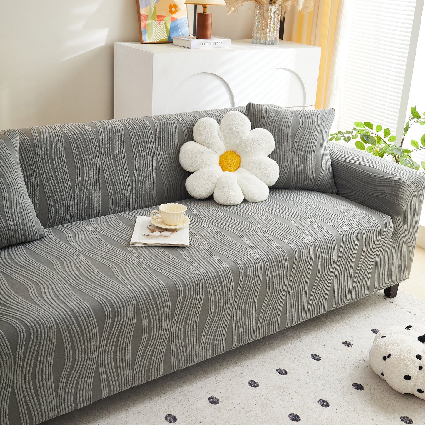 Textured Wave Stretch Sofa Couch Cover, Soft Washable Spandex Furniture Slipcovers on modern gray sofa with floral pillow.