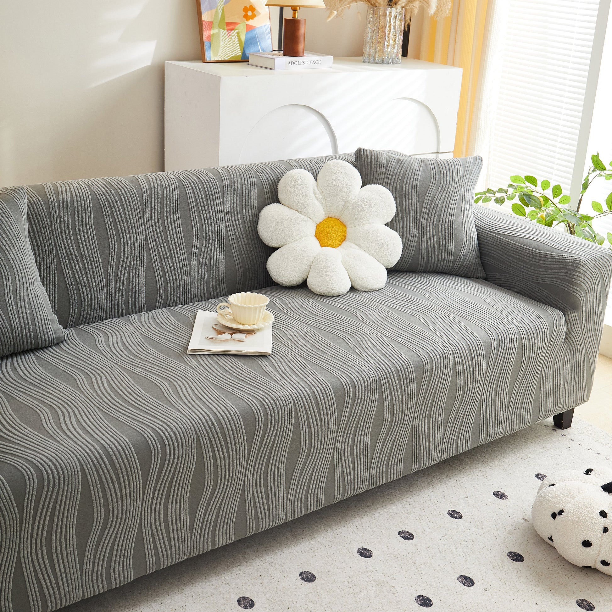 Textured Wave Stretch Sofa Couch Cover, Soft Washable Spandex Furniture Slipcovers on modern gray sofa with floral pillow.