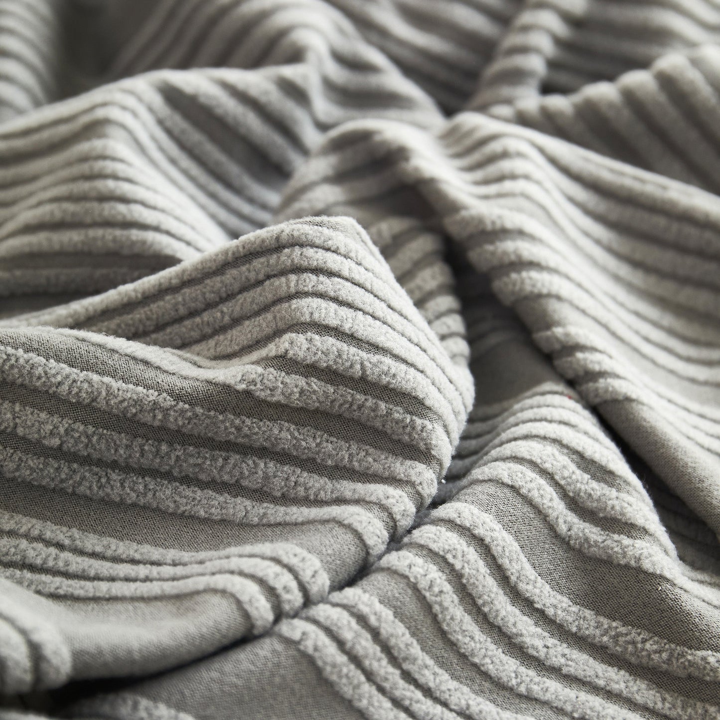 Close-up of the Textured Wave Stretch Sofa Couch Cover fabric showcasing soft, washable spandex slipcover with elegant wave pattern.