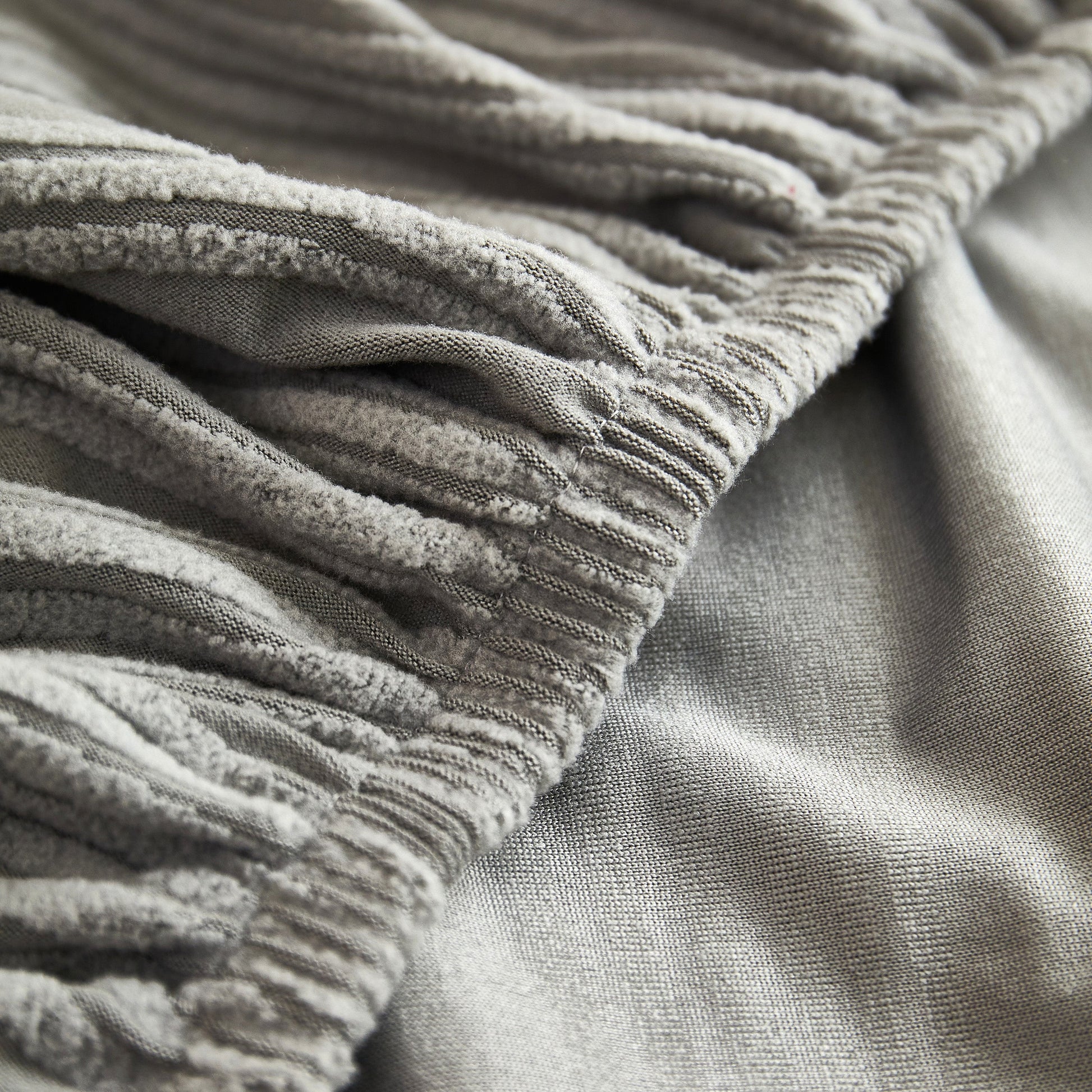 Close-up of Textured Wave Stretch Sofa Couch Cover, Soft Washable Spandex Furniture Slipcovers, showing elegant wave pattern and texture.